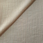 Flat view of Soft Beige Tencel jacquard with subtle woven texture for dresses and layers.