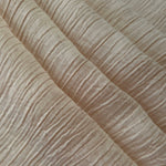 Folded Soft Beige Tencel jacquard with subtle woven texture for blouse and skirt layers.