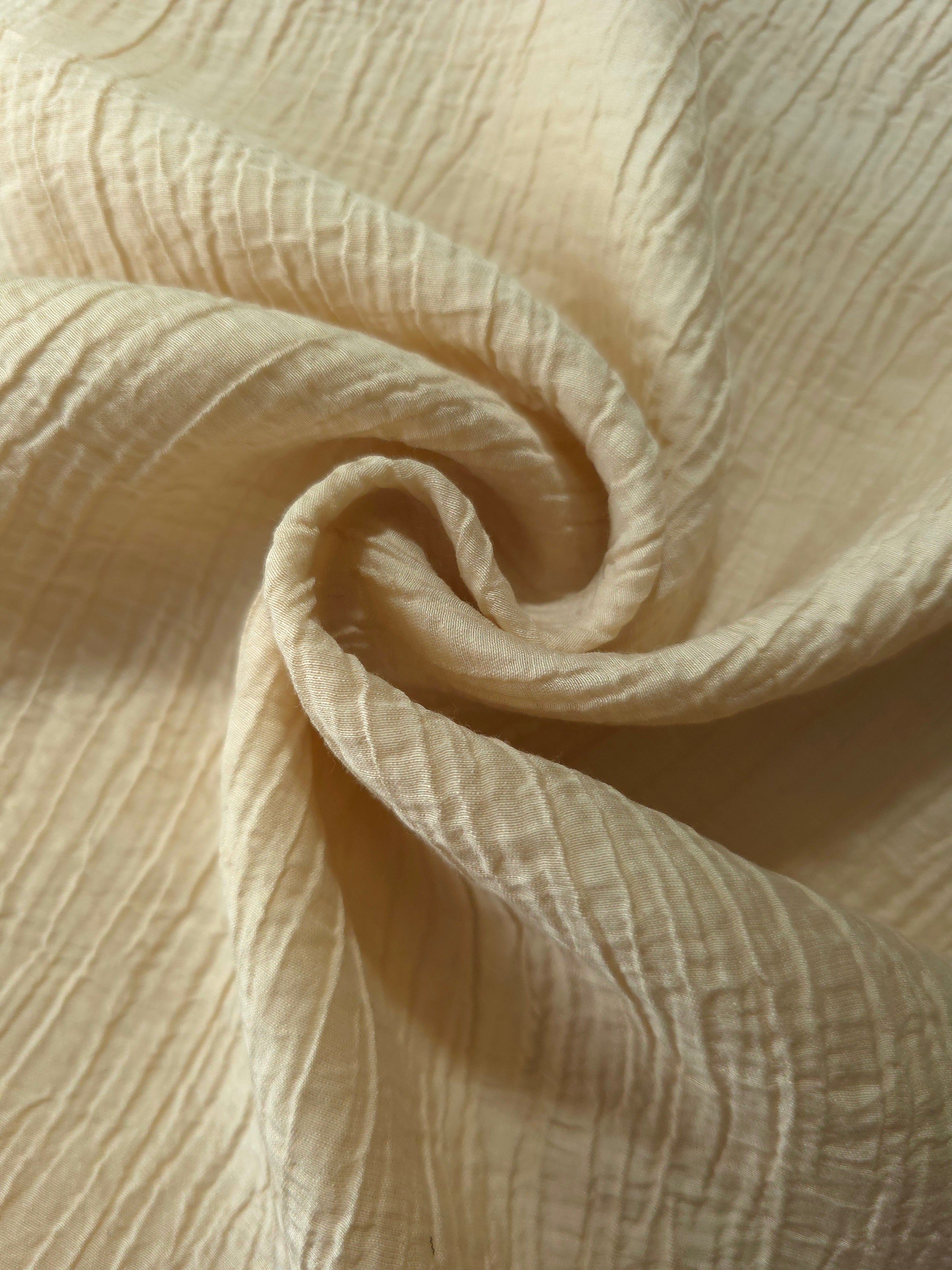 Folded Butter Yellow Tencel jacquard with subtle woven texture for blouse and skirt layers.