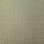 Detail view of Butter Yellow Tencel jacquard with subtle woven texture for soft layers.