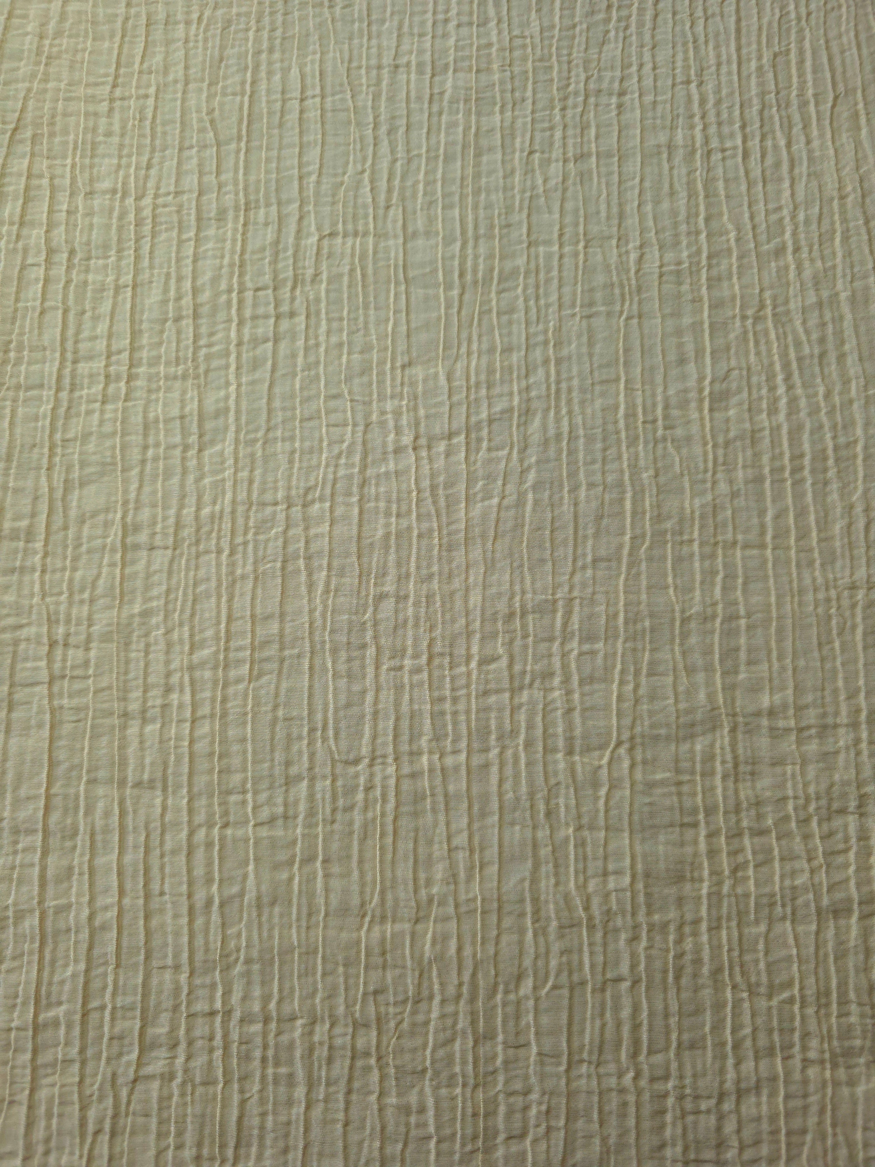 Detail view of Butter Yellow Tencel jacquard with subtle woven texture for soft layers.