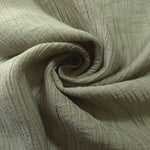 Folded Sage Green Tencel jacquard with subtle woven texture for blouse and skirt layers.