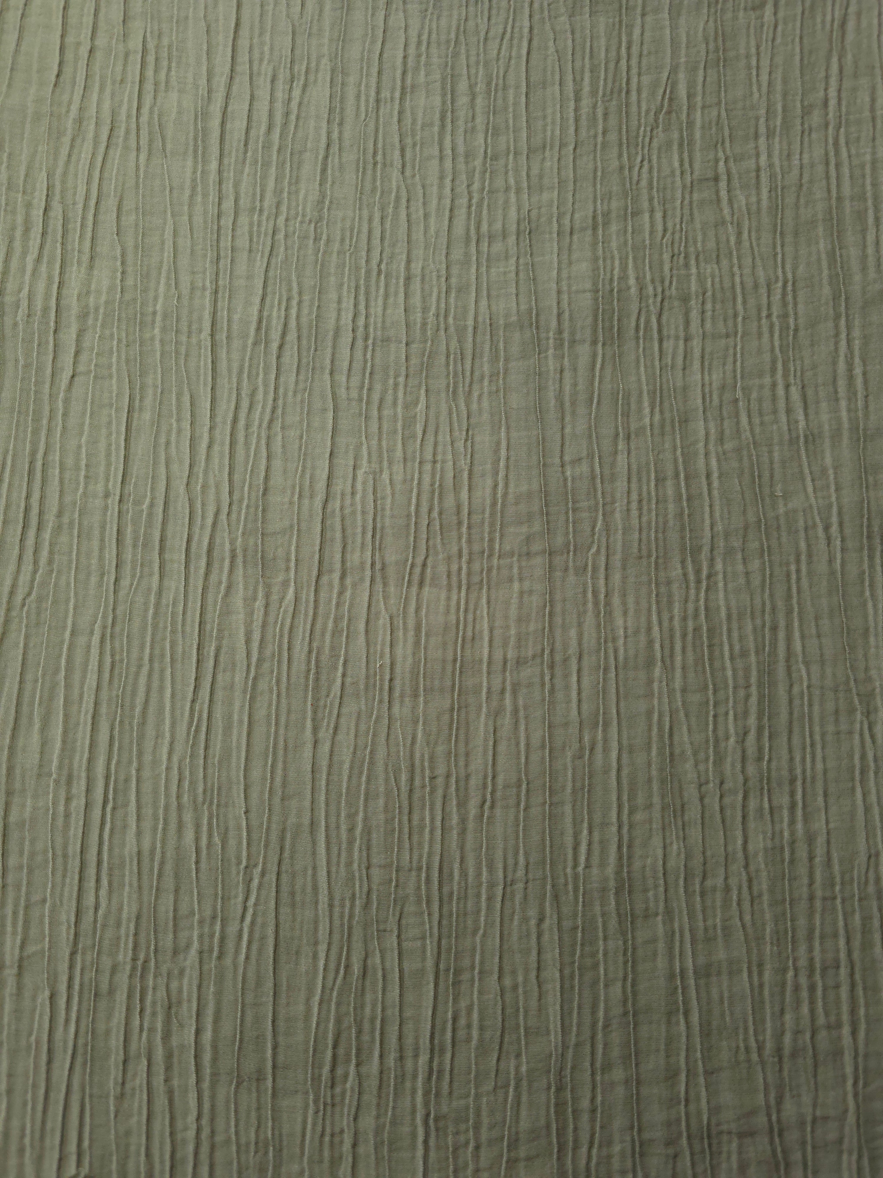 Detail view of Sage Green Tencel jacquard with subtle woven texture for soft layers.