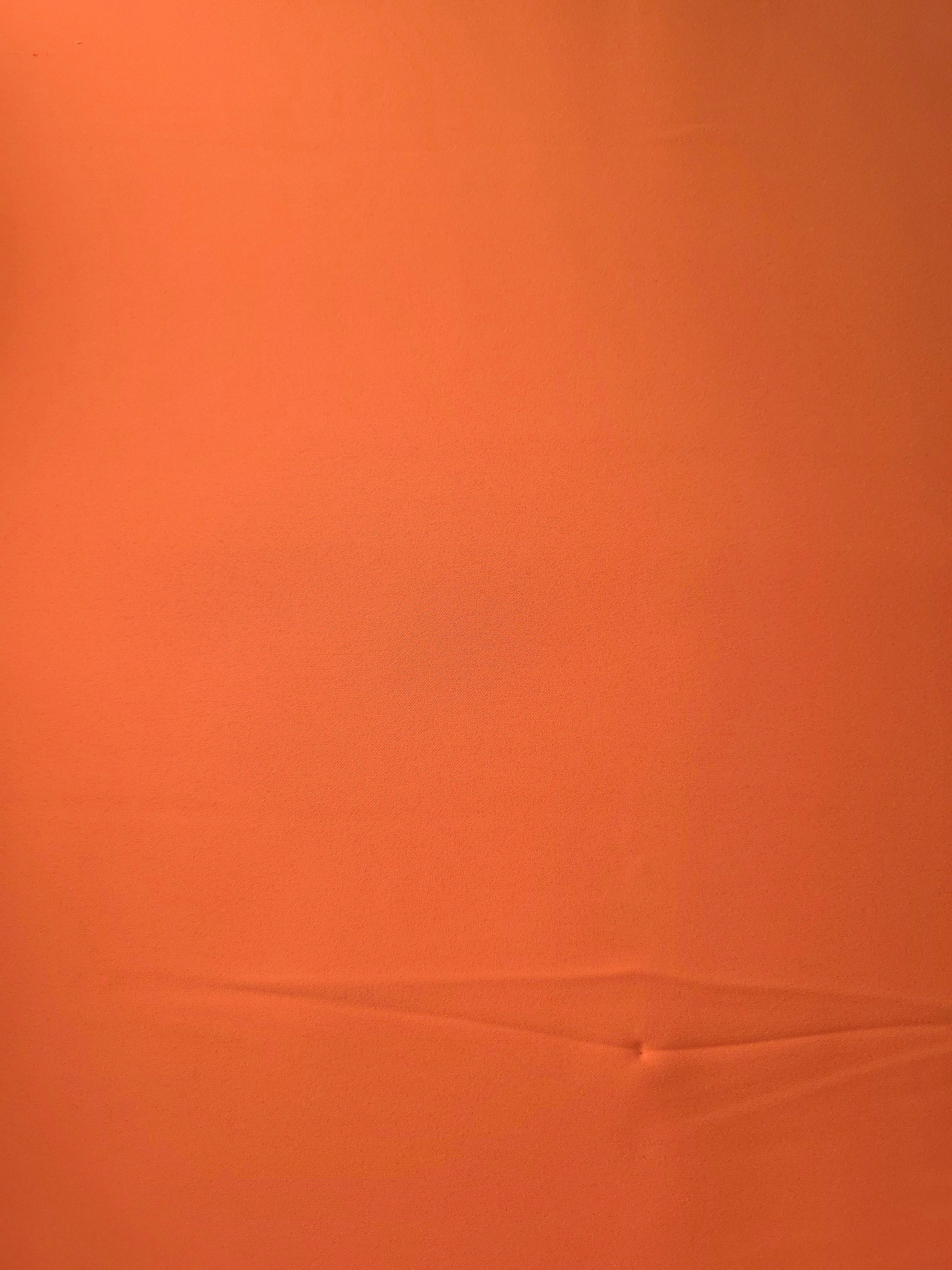 Terracotta Orange Italian polyester crepe shown flat, smooth woven dressmaking fabric with a silky-soft finish
