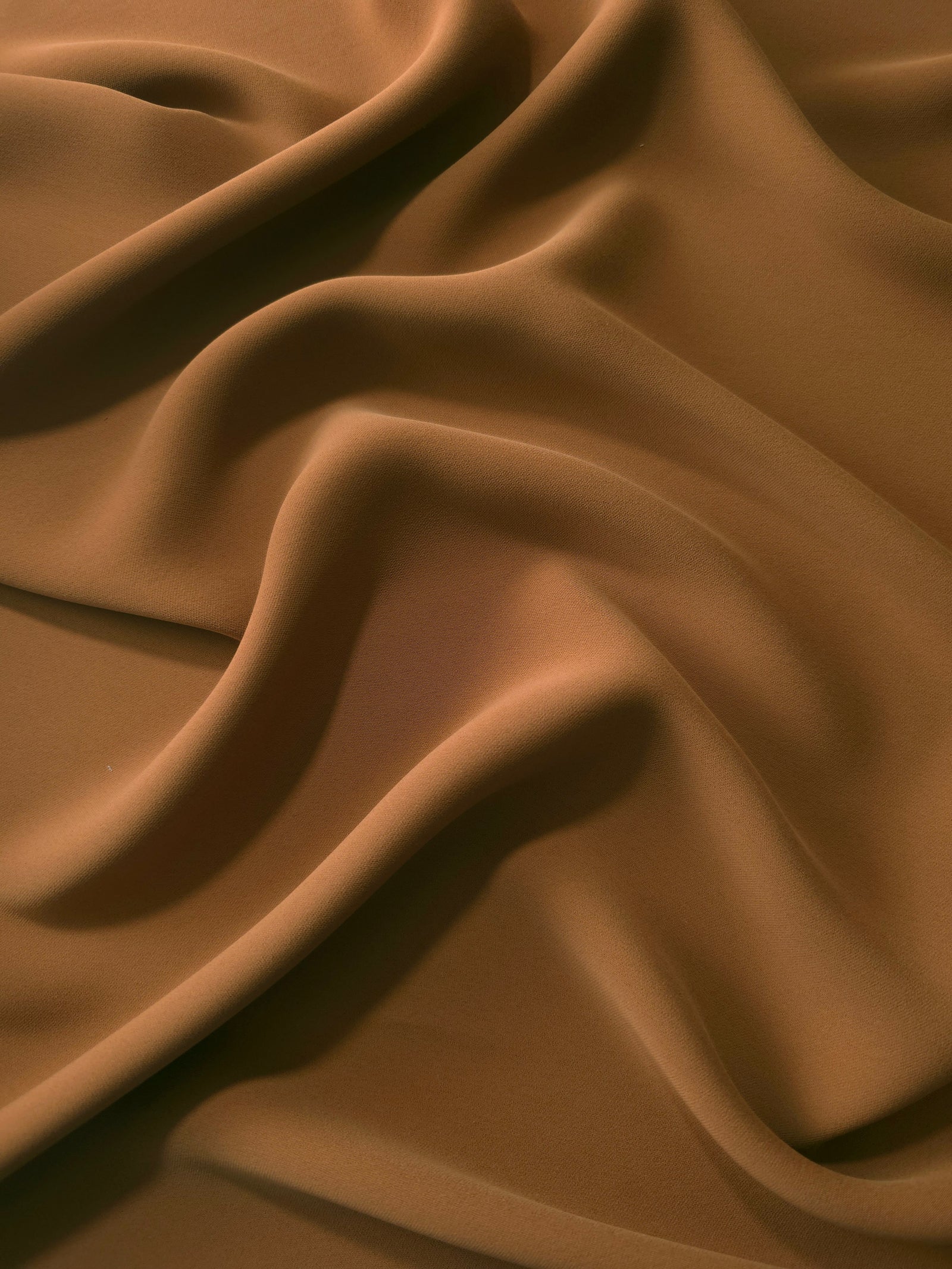 Draped Toffee Brown Korean polyester crepe showing opaque fluid folds for evening dresses and occasionwear