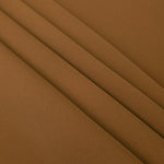 Layered Toffee Brown mechanical polyester crepe showing soft structure and slight mechanical stretch for tailoring