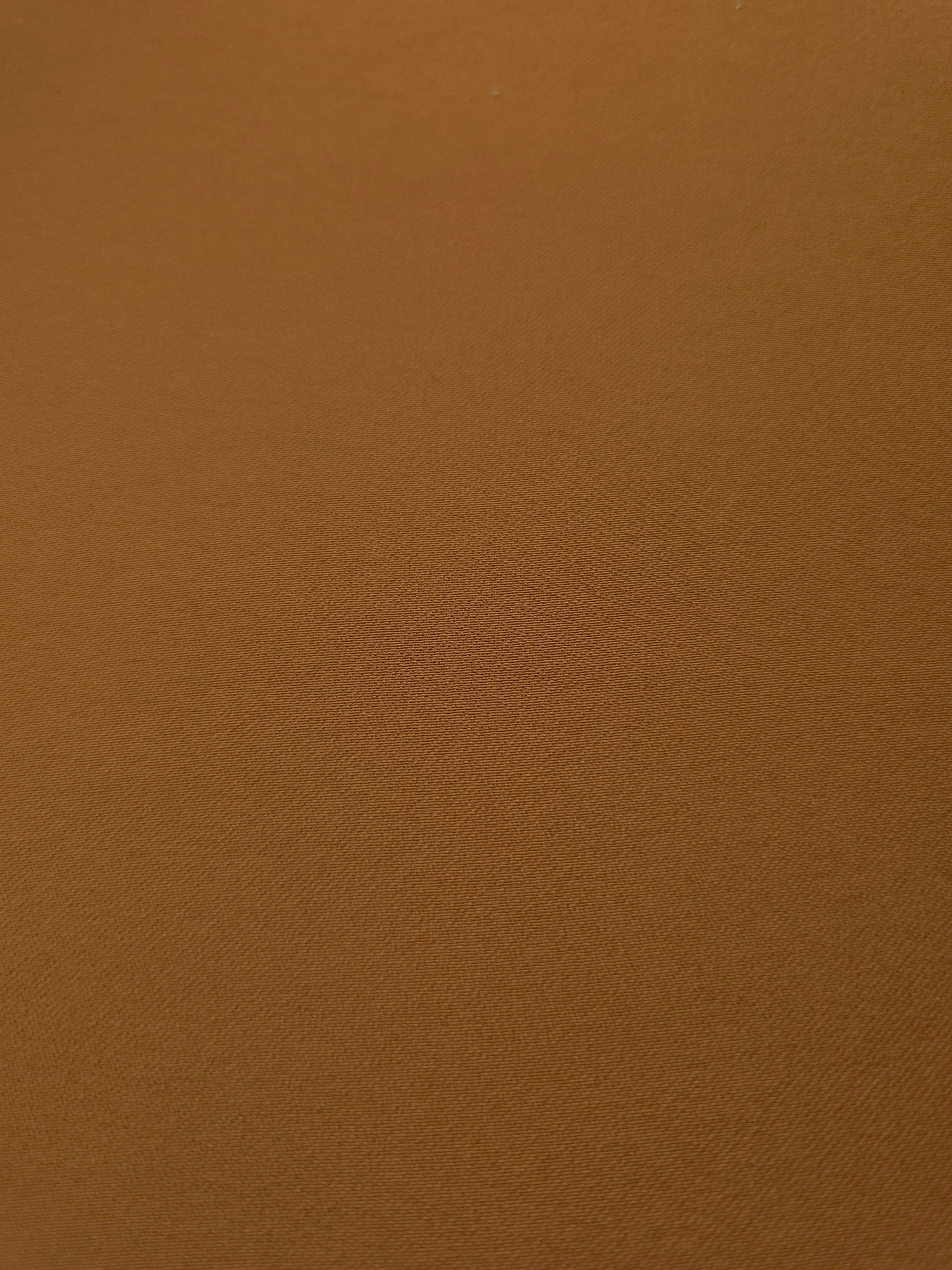 Close-up of Toffee Brown 100% mechanical polyester crepe showing fine woven texture and a silky-soft hand feel