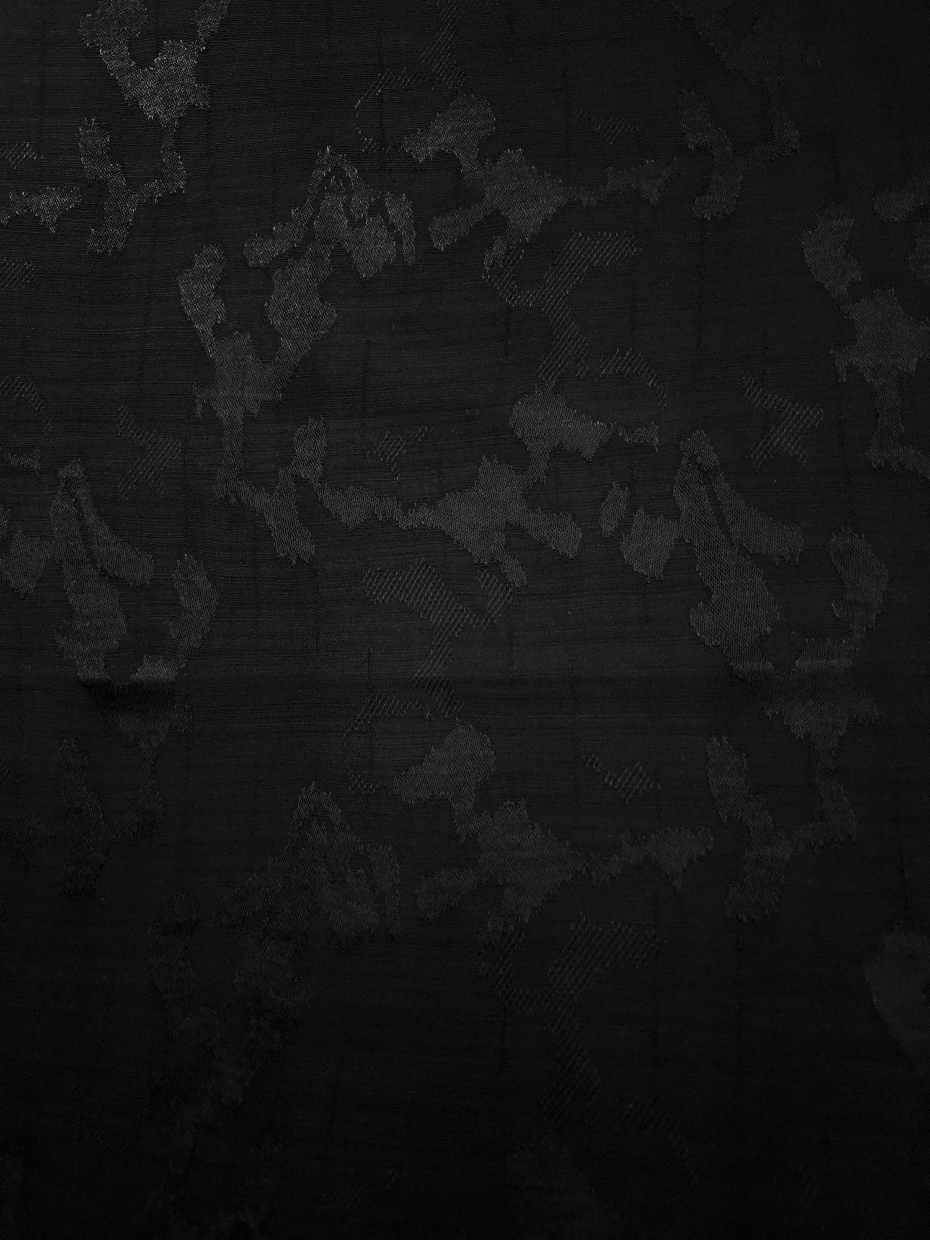 Full abstract botanical motif across jet black tone-on-tone jacquard for evening dresses, long jackets and coordinated sets.