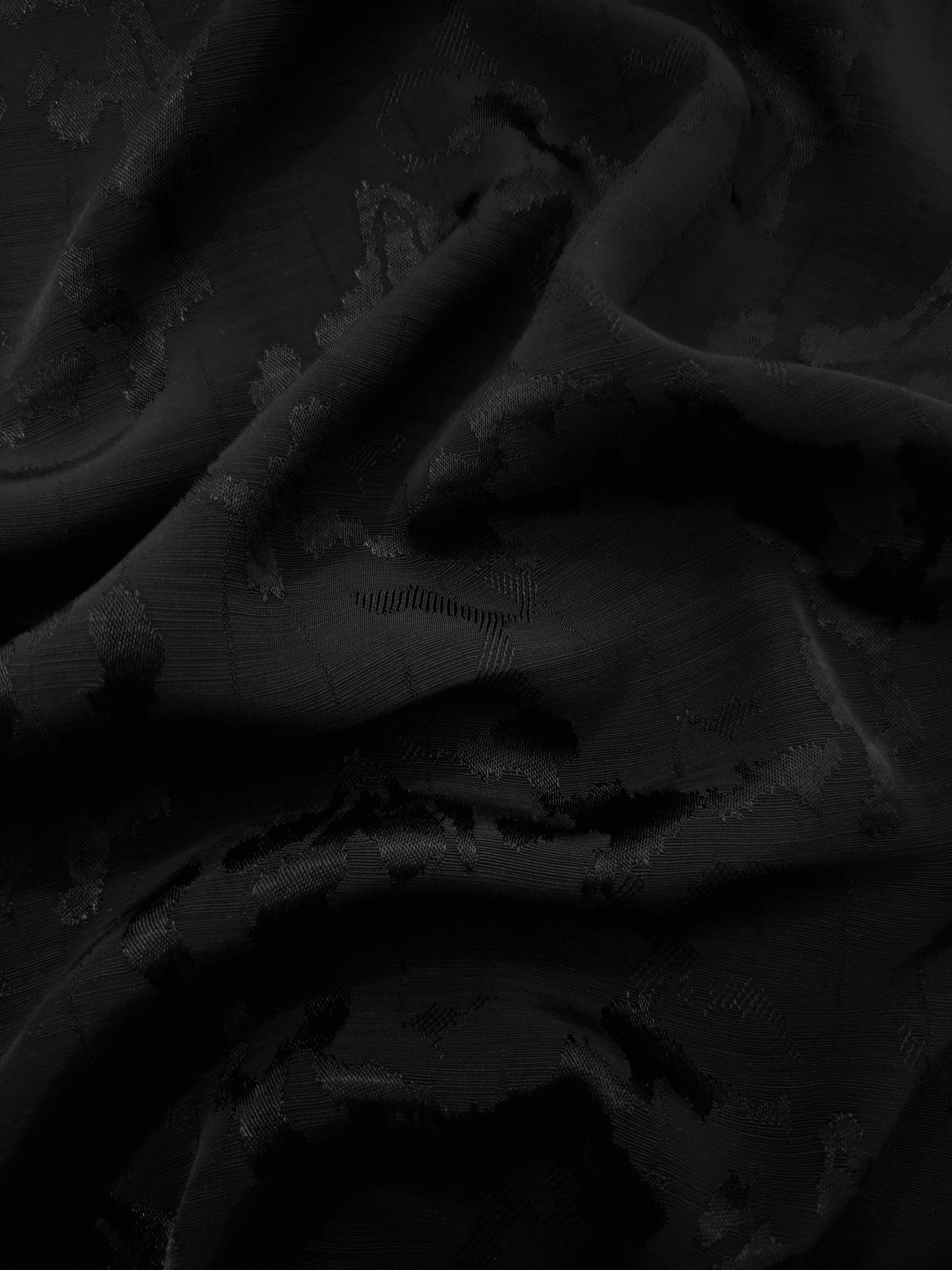 Gathered jet black abstract botanical viscose jacquard showing fluid volume for abayas, draped dresses and full-length skirts.
