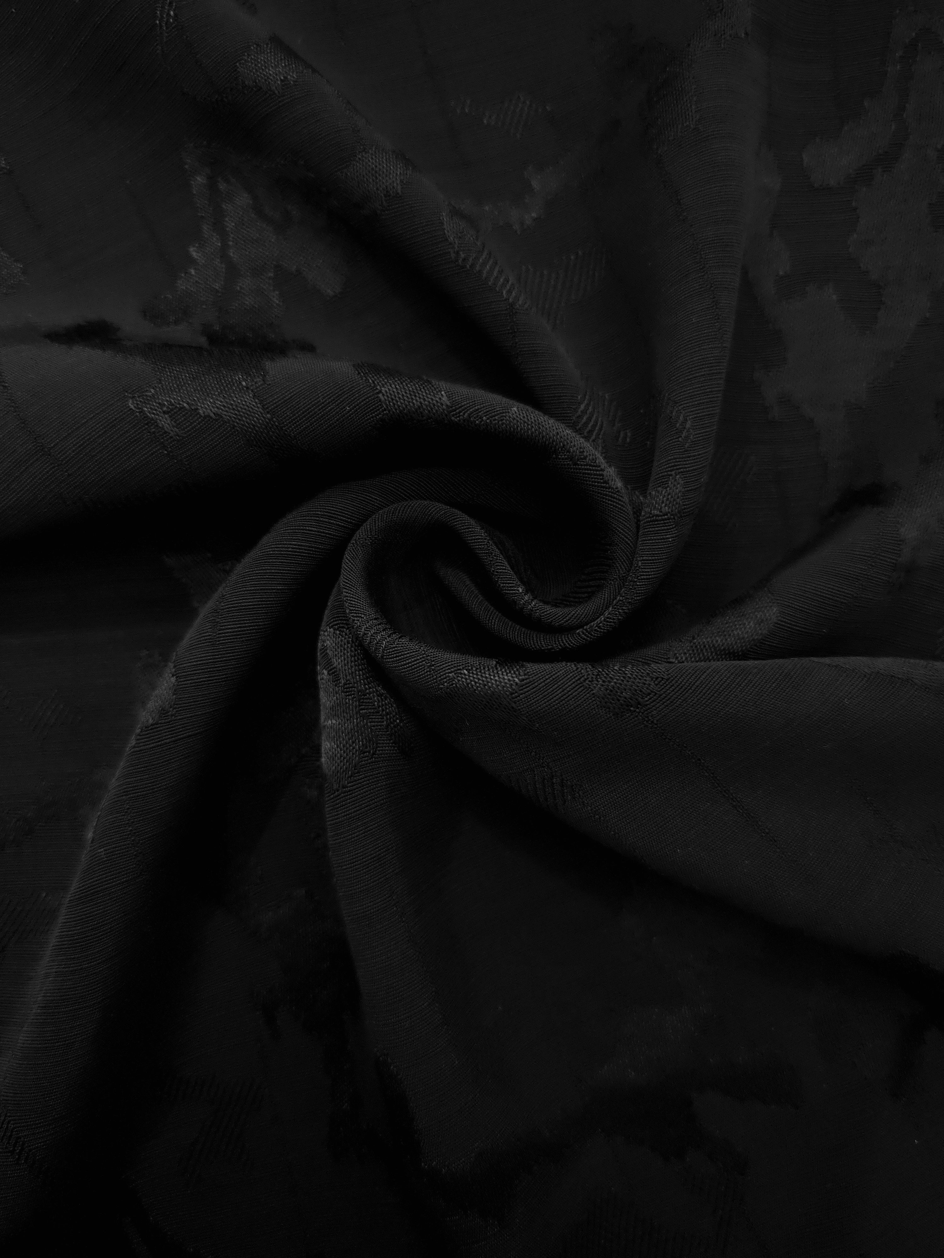 Spiral drape of jet black abstract floral rayon jacquard demonstrating graceful movement for gowns, wrap skirts and kimono robes.