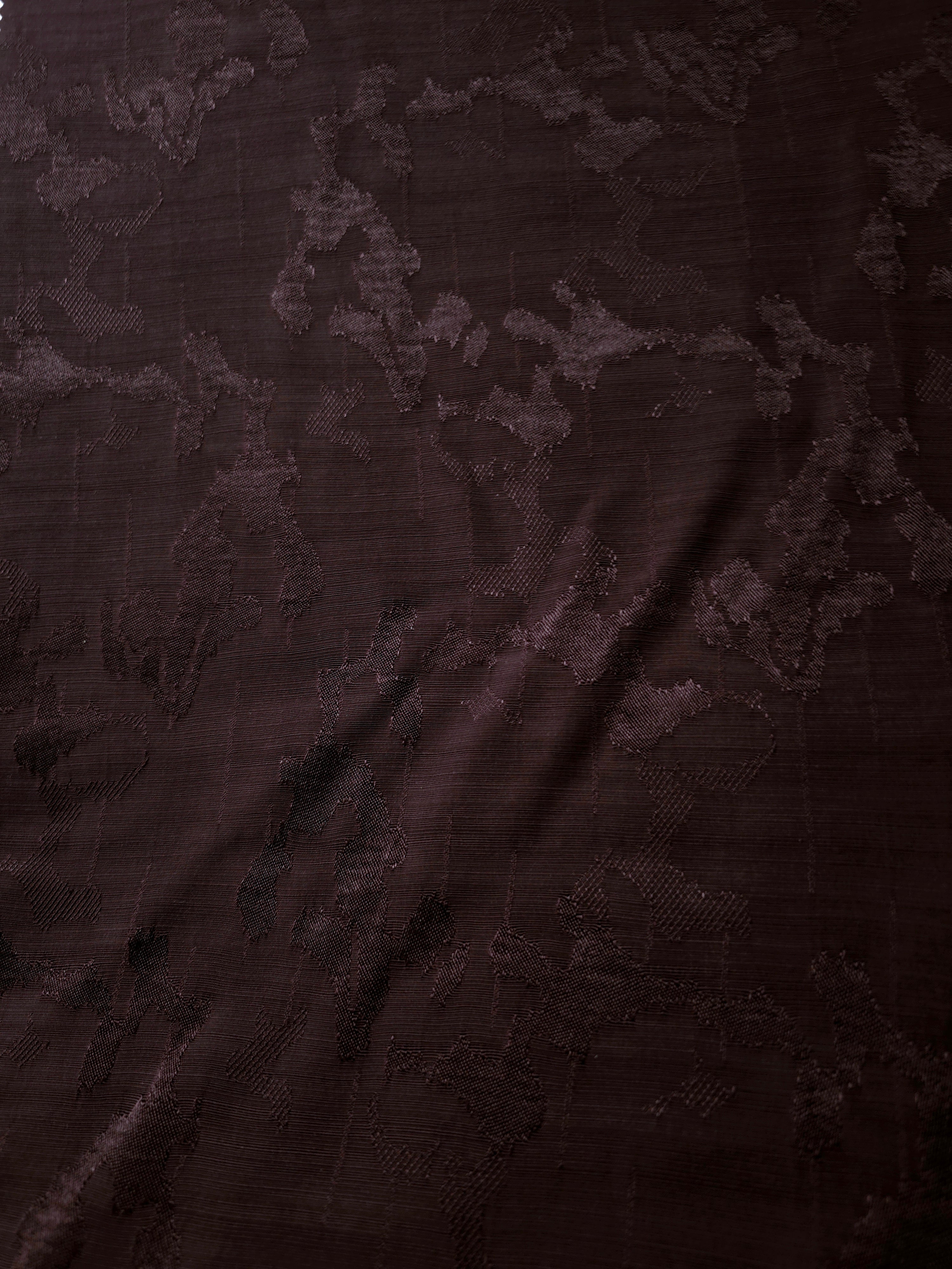 Wide view of the abstract botanical repeat in wine burgundy tone-on-tone jacquard for skirts, dresses and two-piece ensembles.