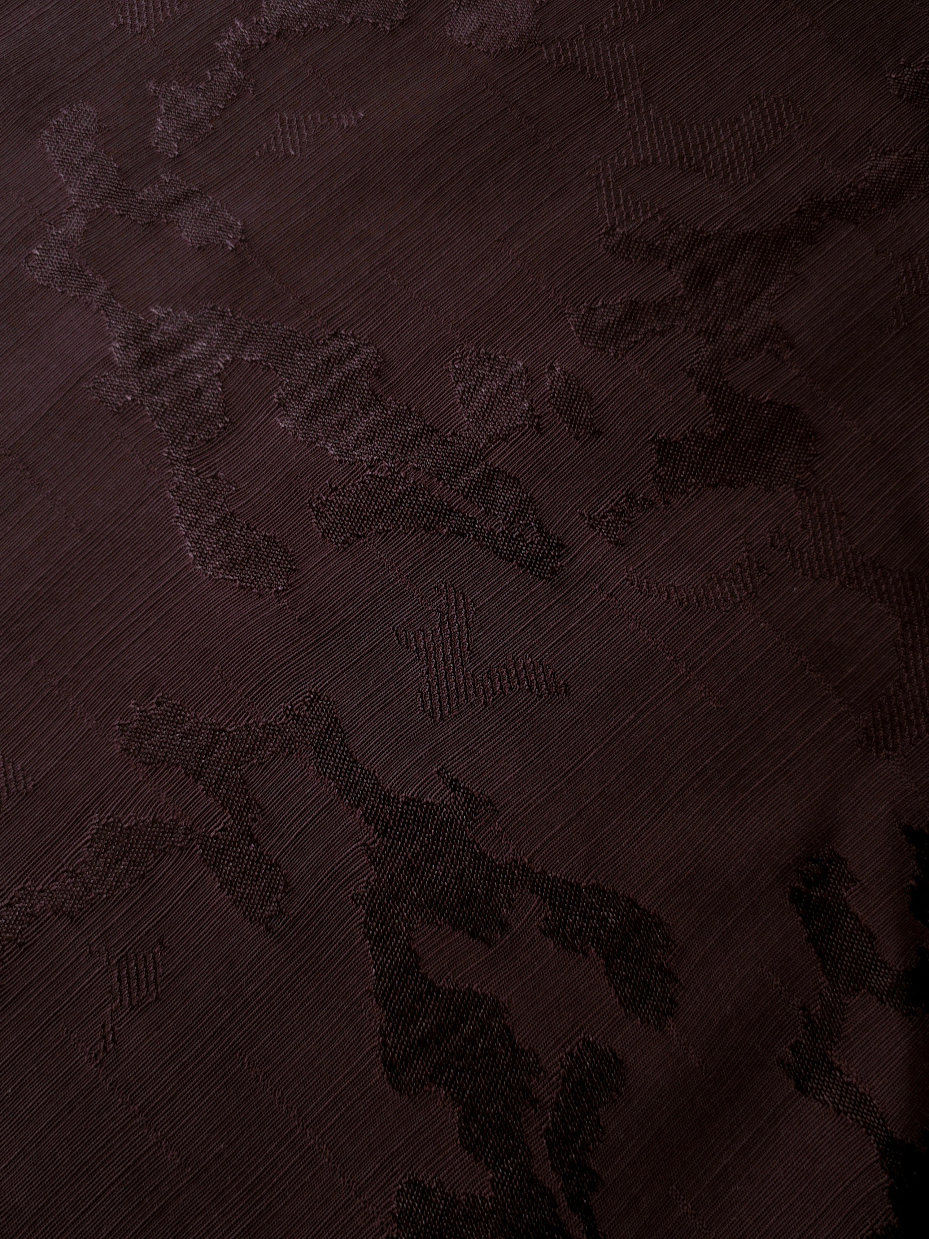 Close textile detail of wine burgundy botanical viscose jacquard for sophisticated blouses, dress panels and couture-inspired accents.