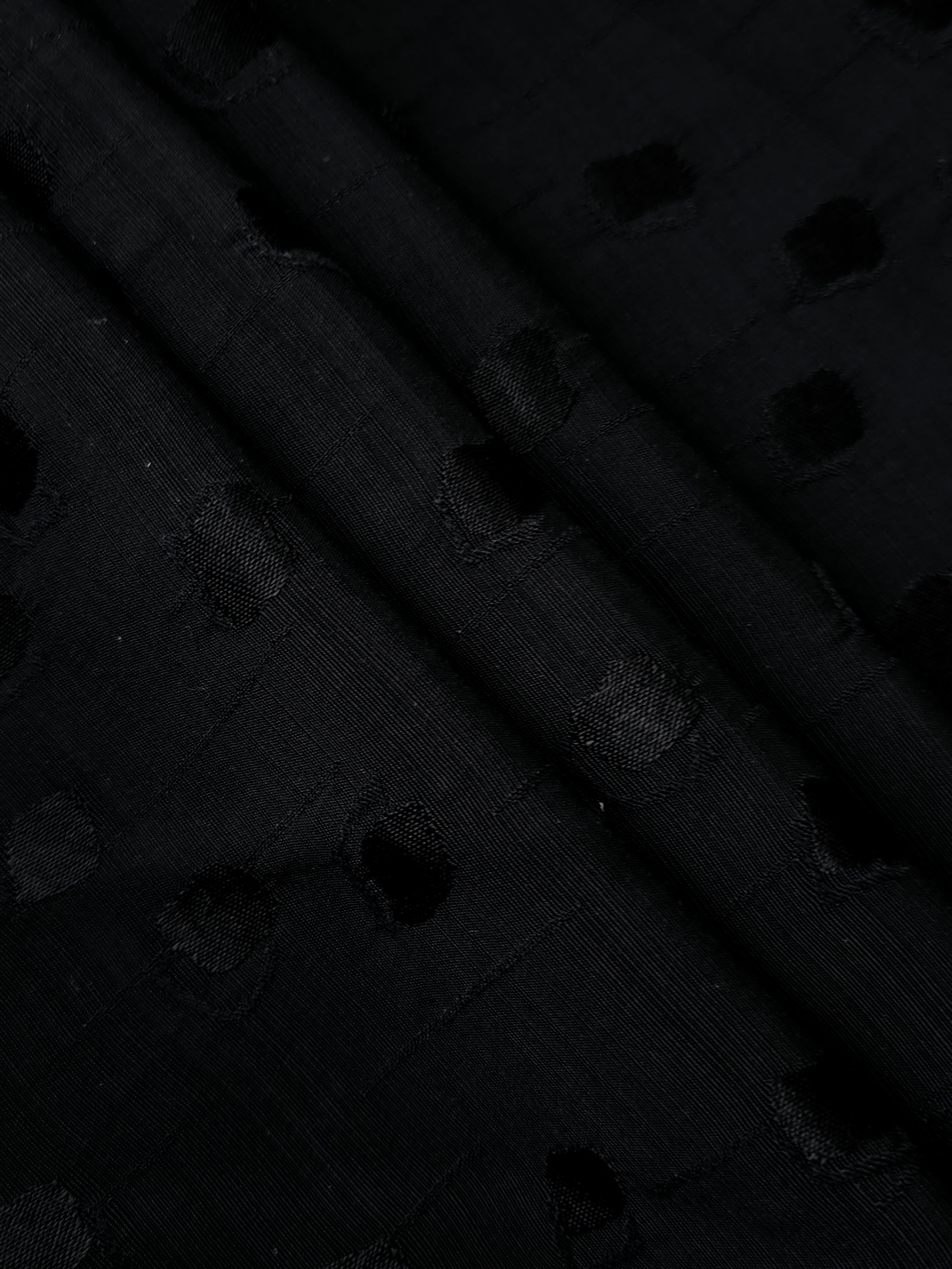 Layered folds of jet black scattered square jacquard revealing tonal sheen and soft body for abayas, wide-leg trousers and structured overshirts.