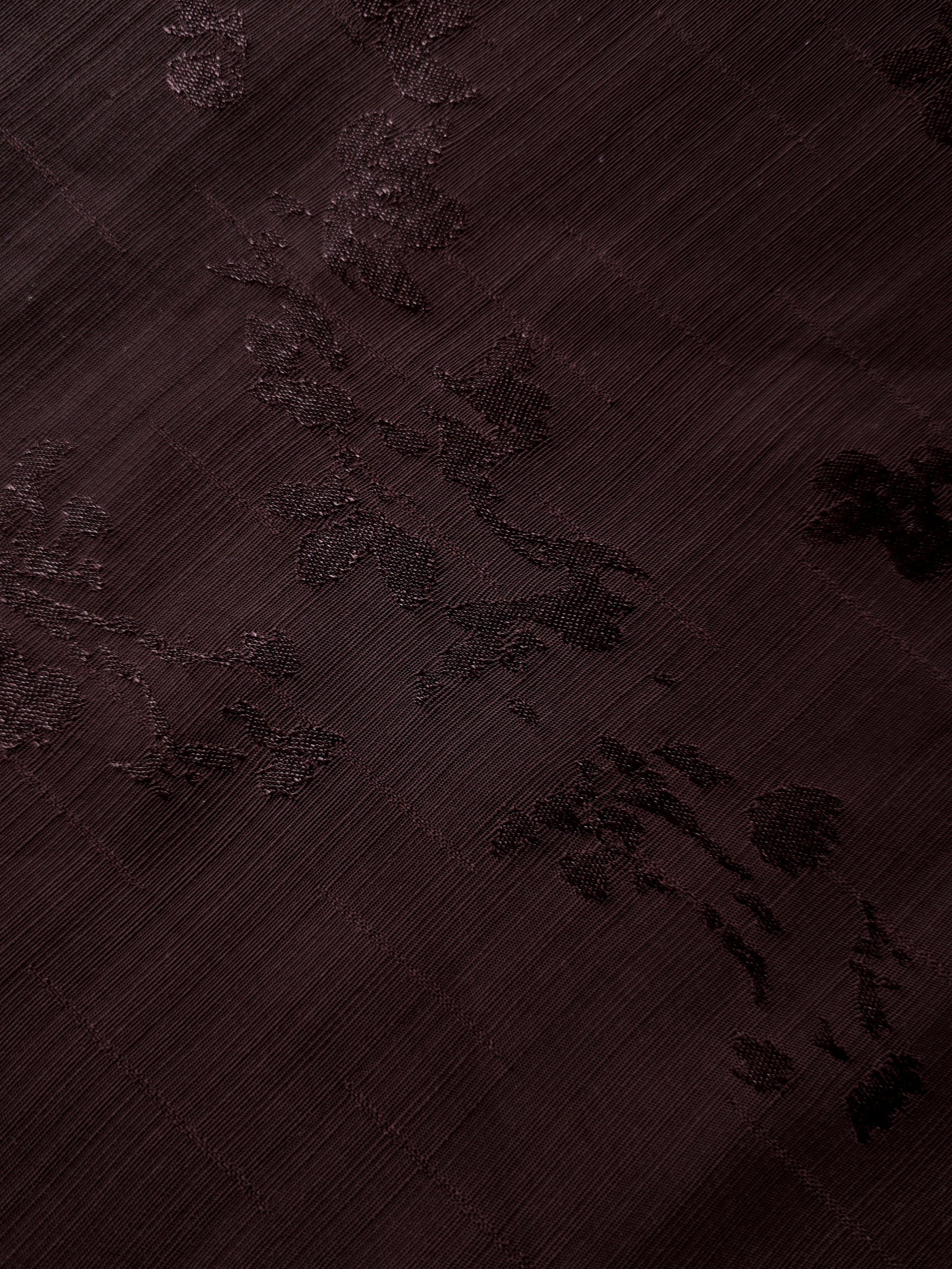 Detailed surface view of deep burgundy trailing rose vine jacquard for premium tunics, elegant shirts and special-occasion garments.