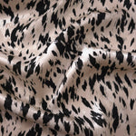 Black animal print Turkish rayon viscose jacquard fabric in a wave drape