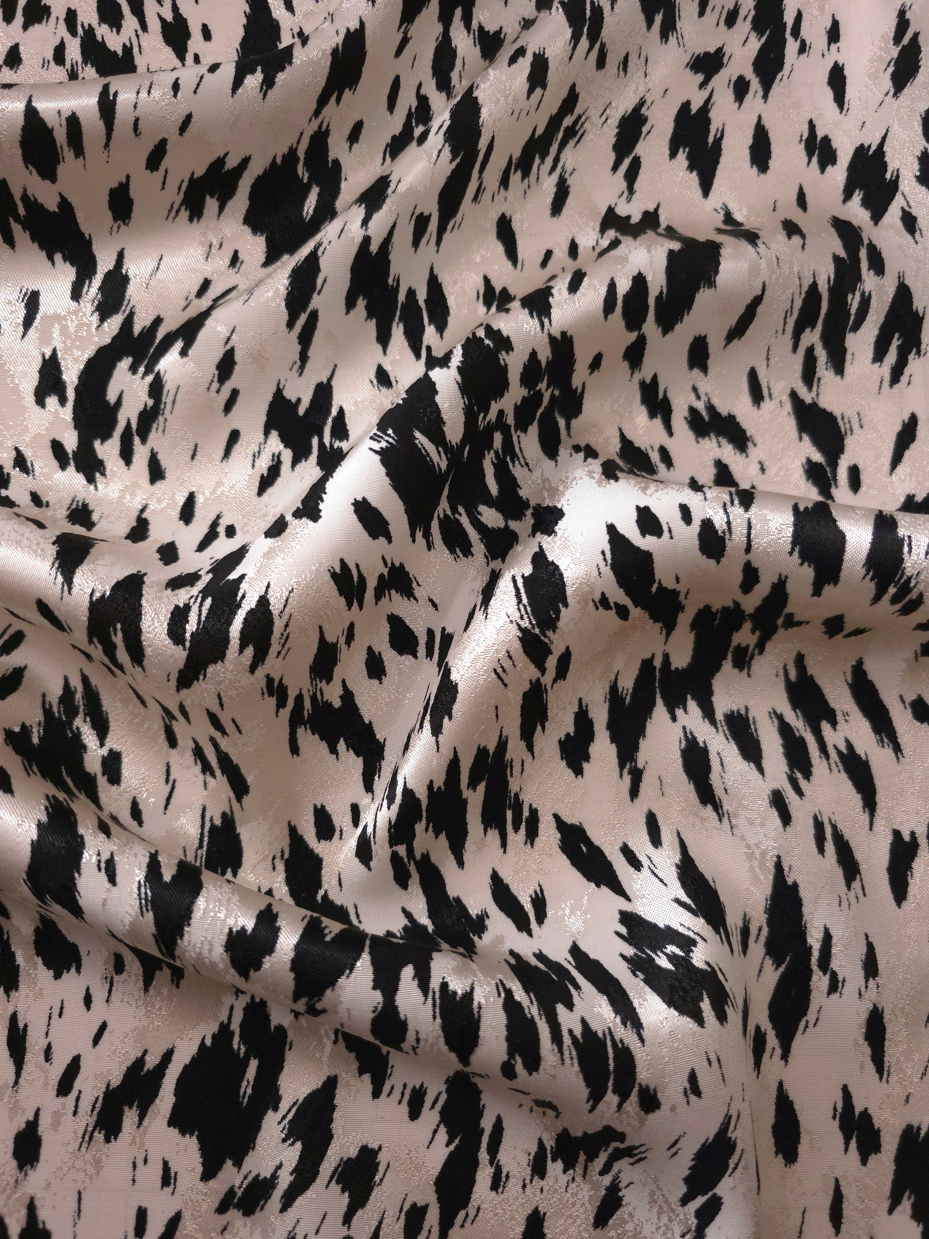 Black animal print Turkish rayon viscose jacquard fabric in a wave drape
