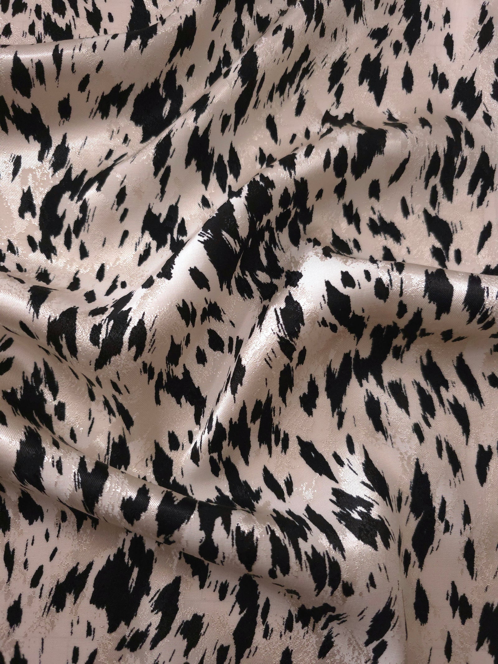 Black animal print Turkish rayon viscose jacquard fabric in a wave drape