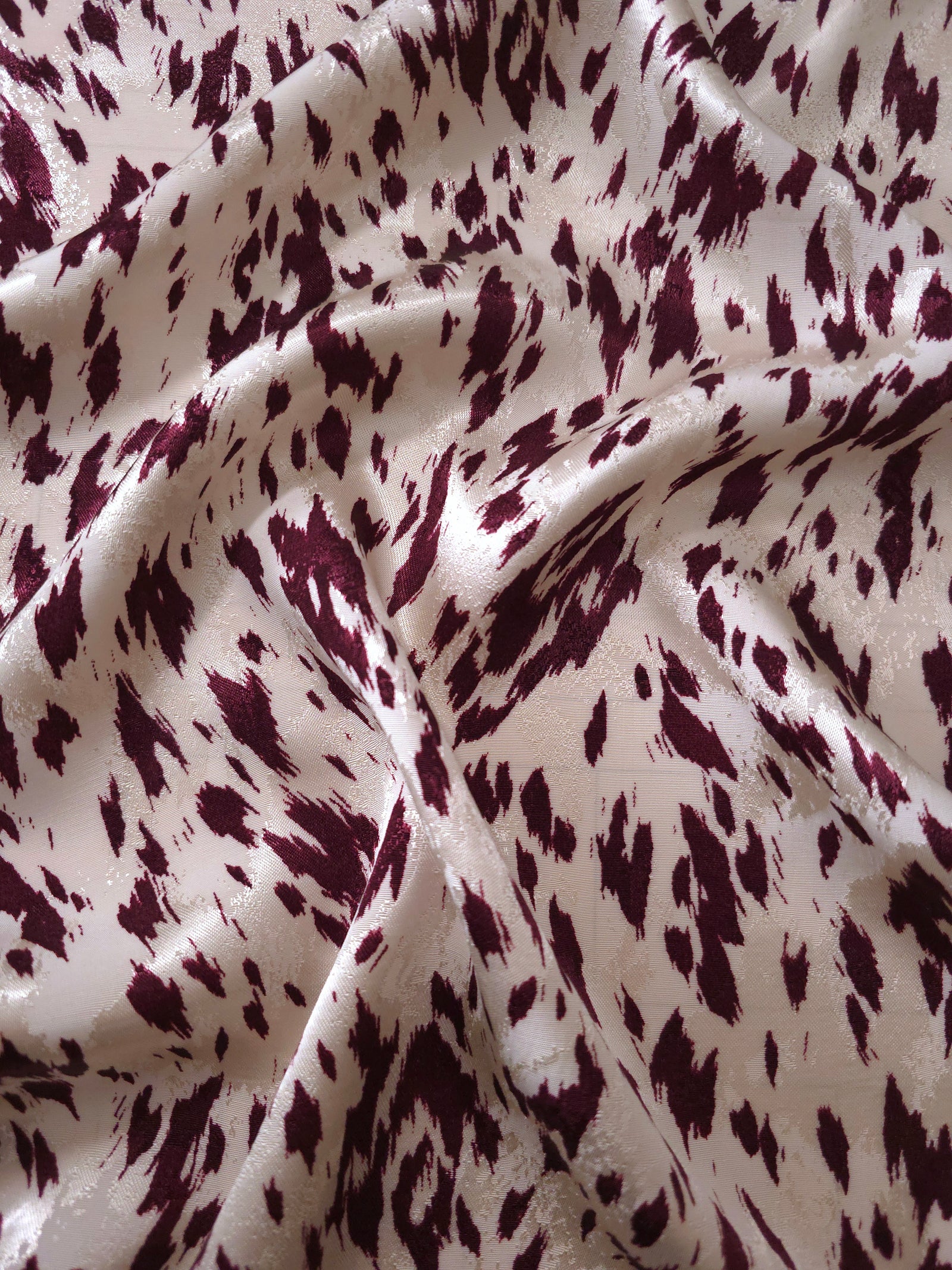 Burgundy animal print Turkish rayon viscose jacquard fabric in a wave drape