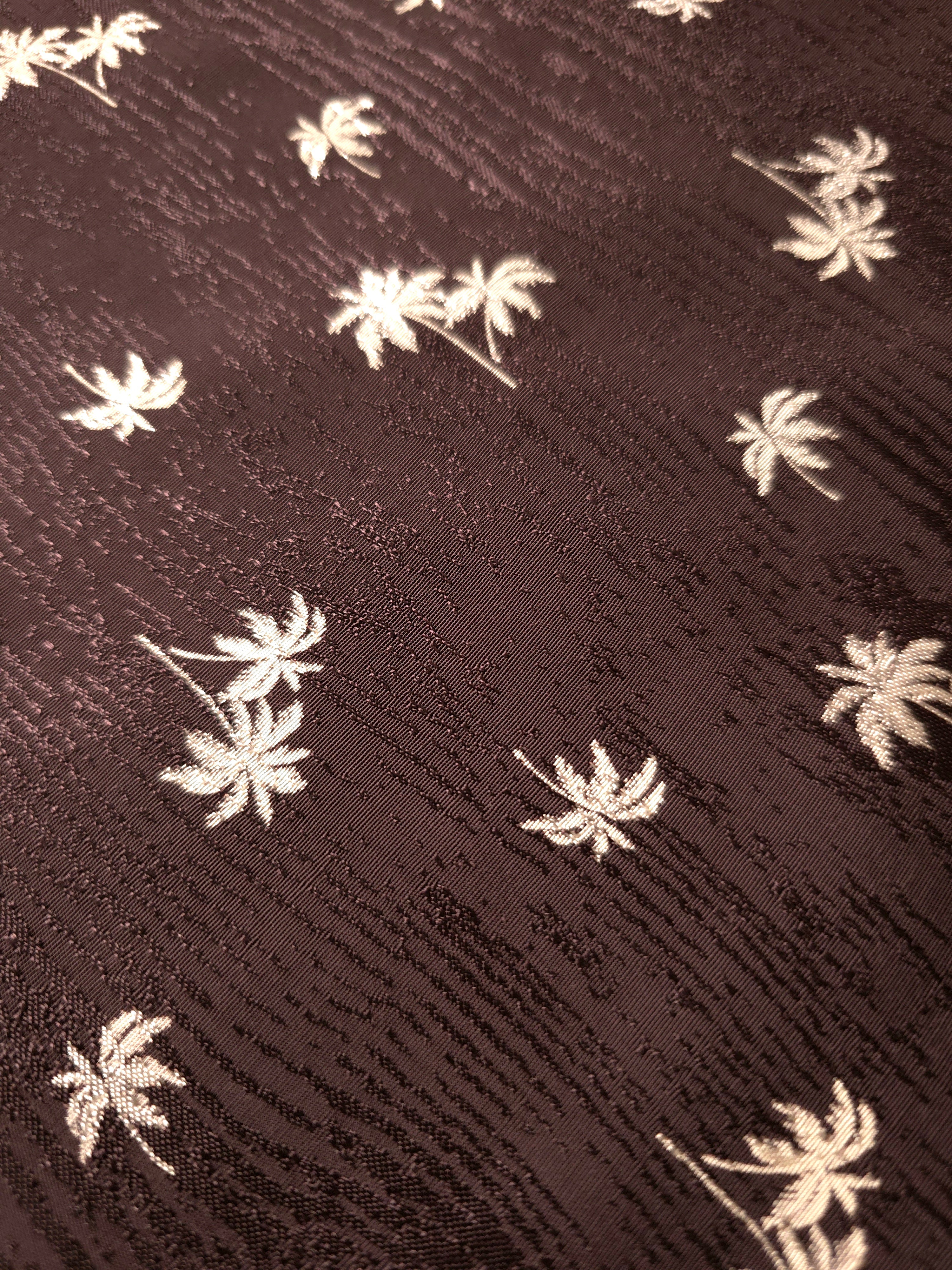 Close texture detail of mocha brown palm print jacquard for refined sleeves, yokes and boutique tops.