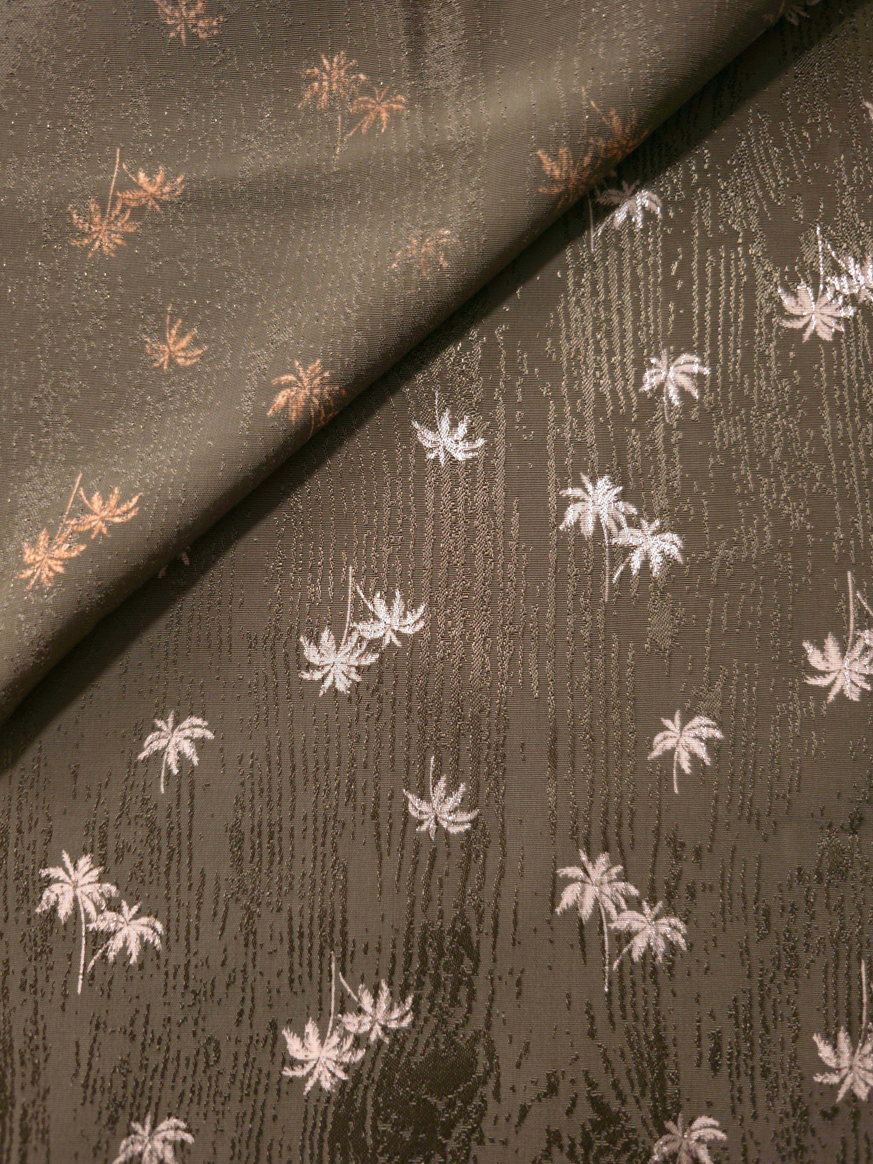 Front and reverse of olive green printed jacquard, showing both fabric faces for abayas and lightweight kaftans.