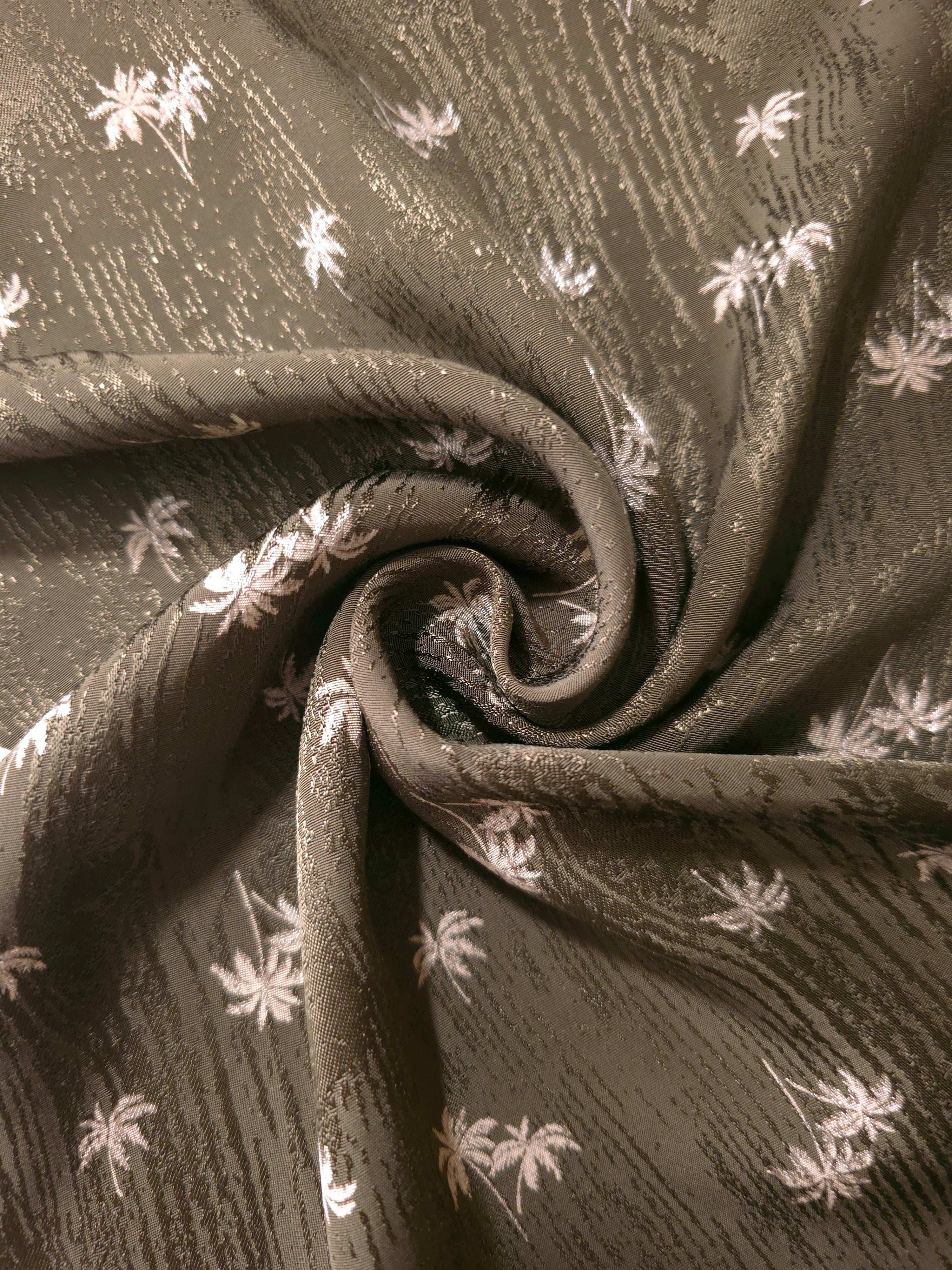 Gathered olive green jacquard showing fluid movement suited to wrap dresses, wide-leg trousers and skirts.