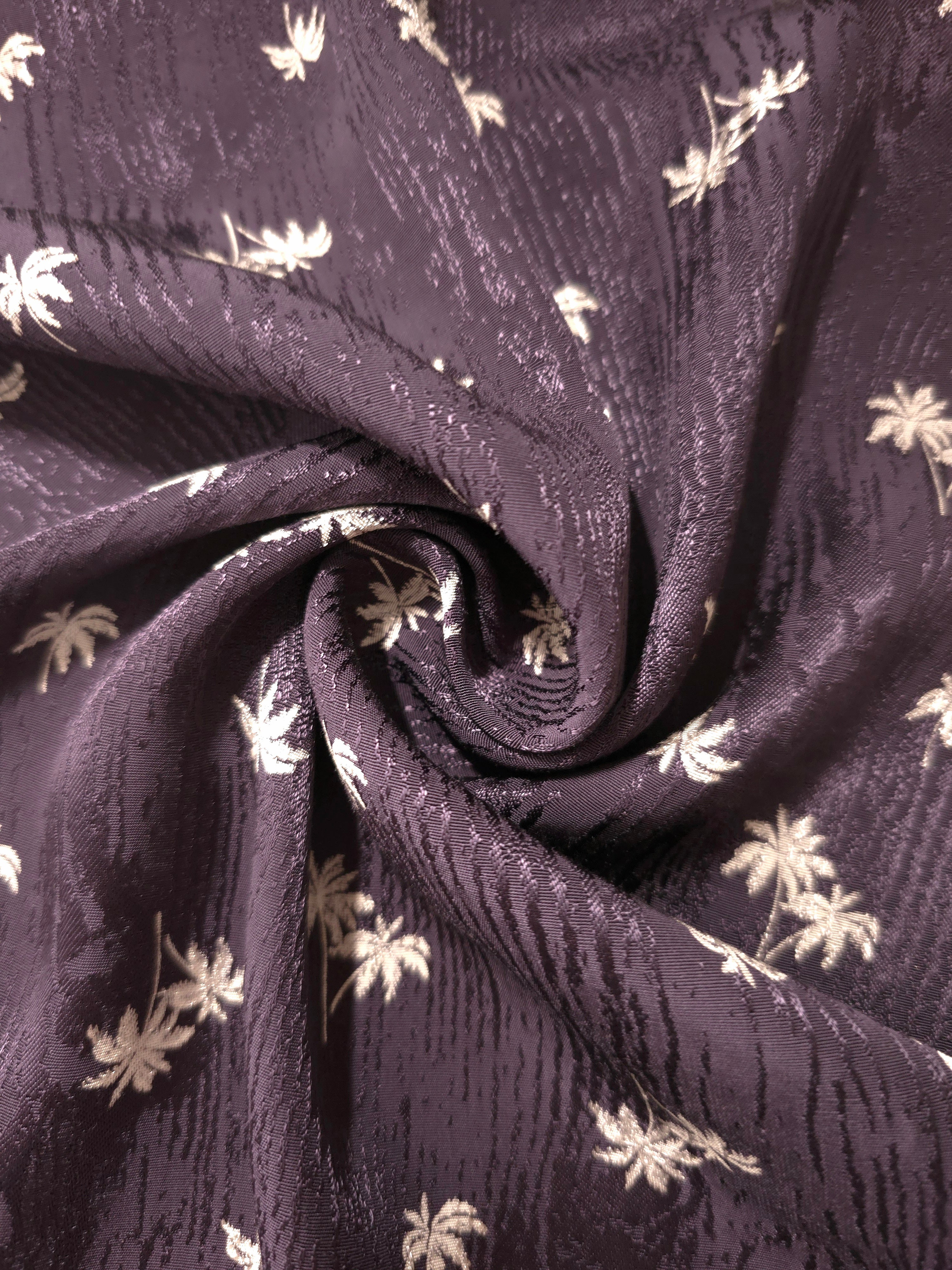Gathered plum purple printed jacquard demonstrating graceful fall for pleated skirts and draped dresses.