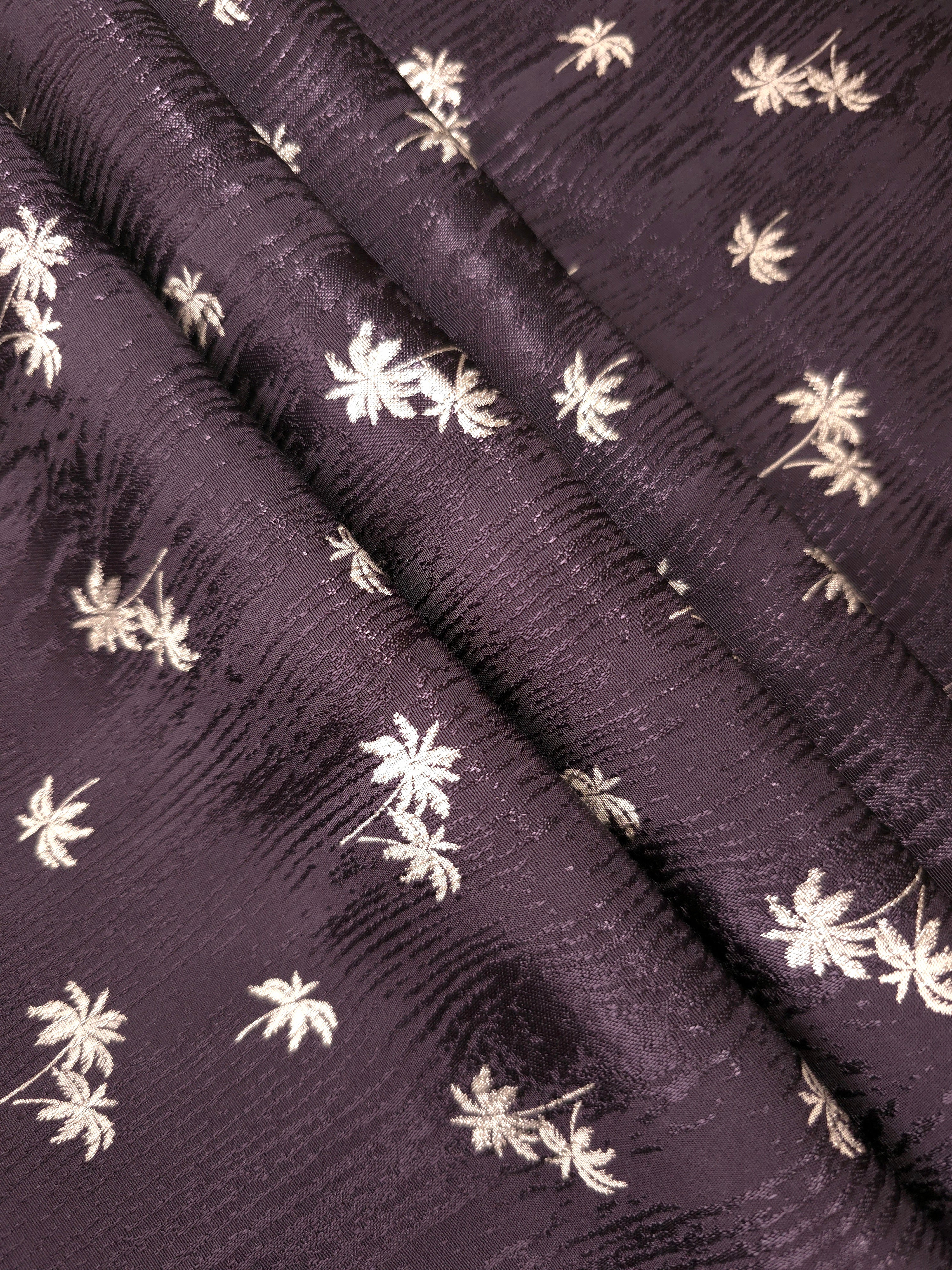 Overlapping plum purple jacquard folds highlighting depth and shine for evening tops and matching separates.