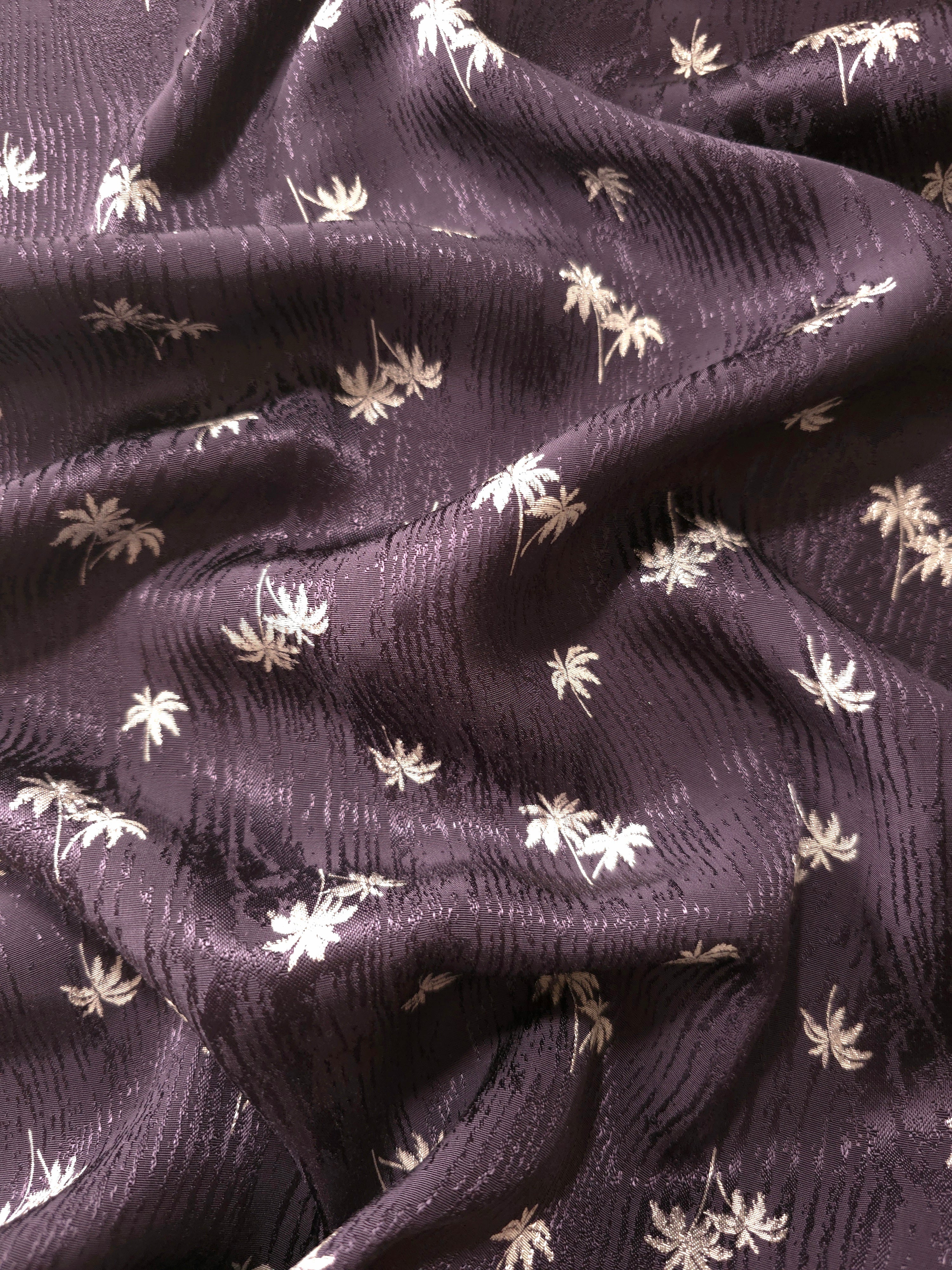 Plum purple mini palm tree jacquard arranged in soft waves, suitable for occasion dresses and flowing abayas.