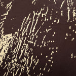 Close-up of Chocolate Brown - Black silky rayon fabric with distressed ink line print and smooth handle.