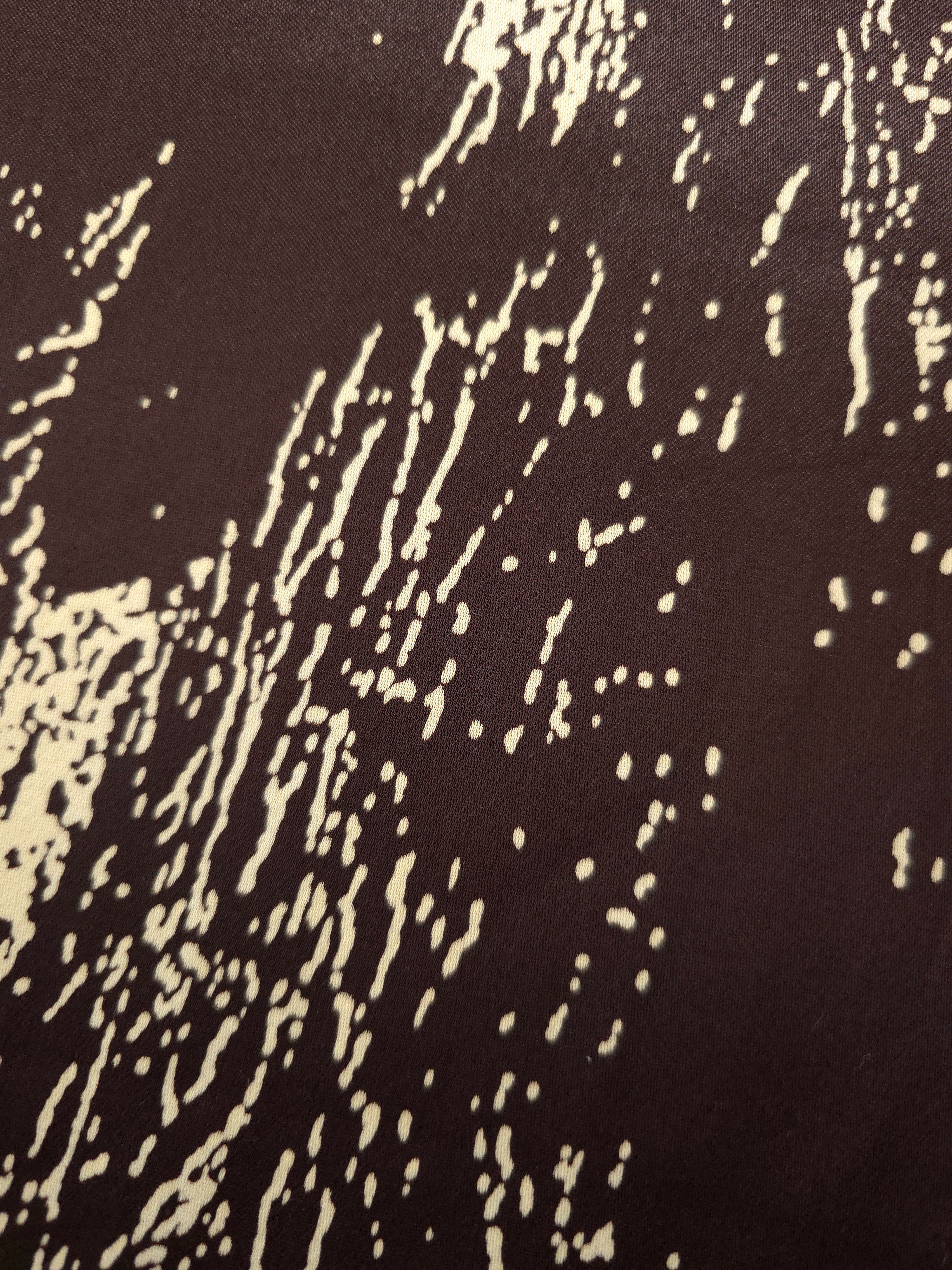 Close-up of Chocolate Brown - Black silky rayon fabric with distressed ink line print and smooth handle.