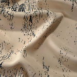 Wave shot of Vanilla Cream - Black silky rayon with distressed ink line print for soft abaya designs.