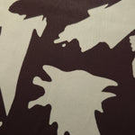 Close-up of Chocolate Brown - Black silky rayon fabric with bold abstract petal print and smooth finish.