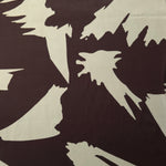 Wide shot of Chocolate Brown - Black silky rayon fabric with bold petal print for boutique modestwear yardage.
