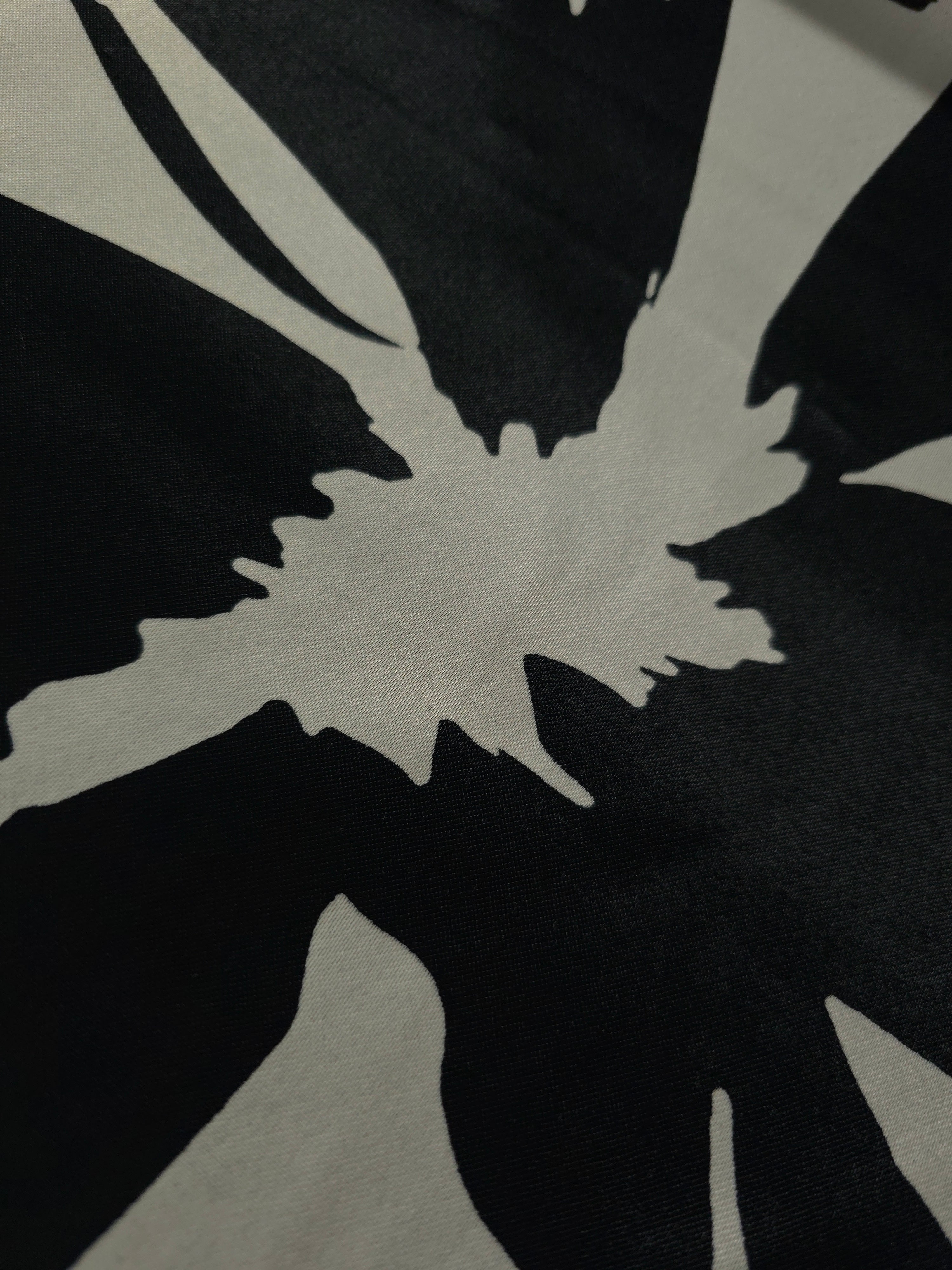Close-up of Formal Black - Charcoal silky rayon fabric with tonal bold abstract petal print for modestwear.