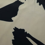 Close-up of Vanilla Cream - Black Turkish silky rayon fabric with bold abstract petal print and smooth surface.