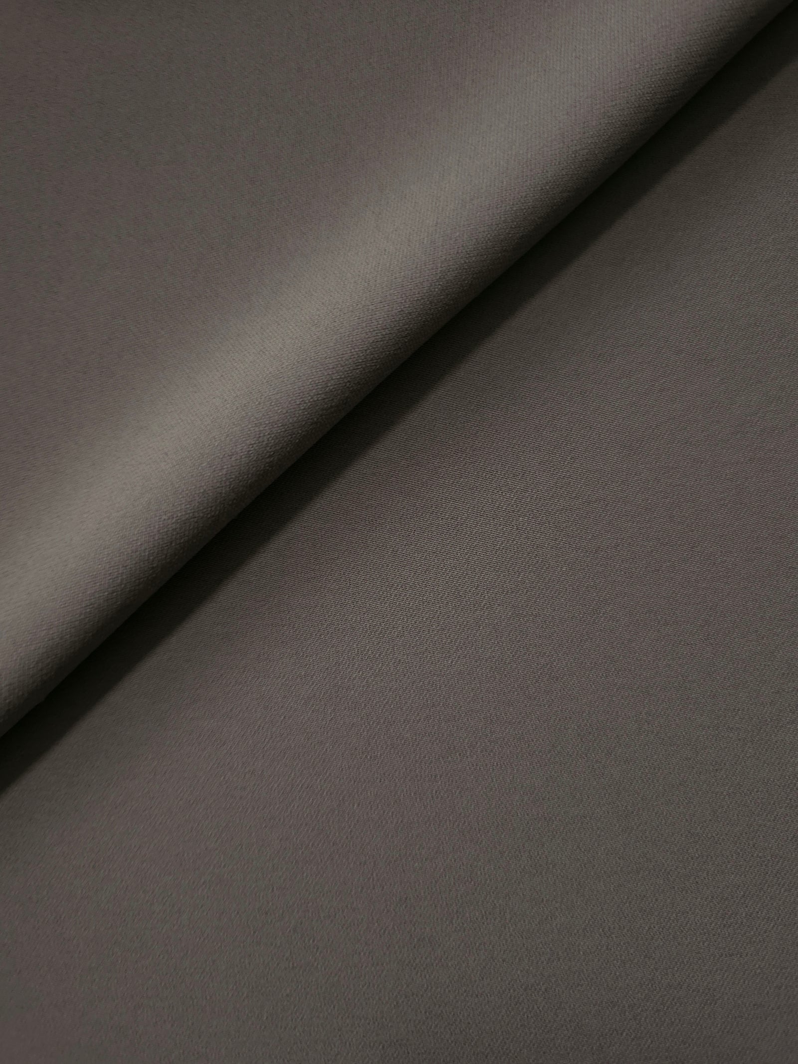 Warm Charcoal Gray Korean polyester crepe in a soft fold, showing fluid drape for blouses and flowing dresses