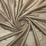 Warm Greige Beige shimmer foiled stretch fabric arranged in a swirl, highlighting movement and reflective finish for performancewear