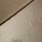 Warm Greige Beige shimmer spandex in a soft fold, showing metallic foil sheen and flexible drape for tops, skirts and costumes