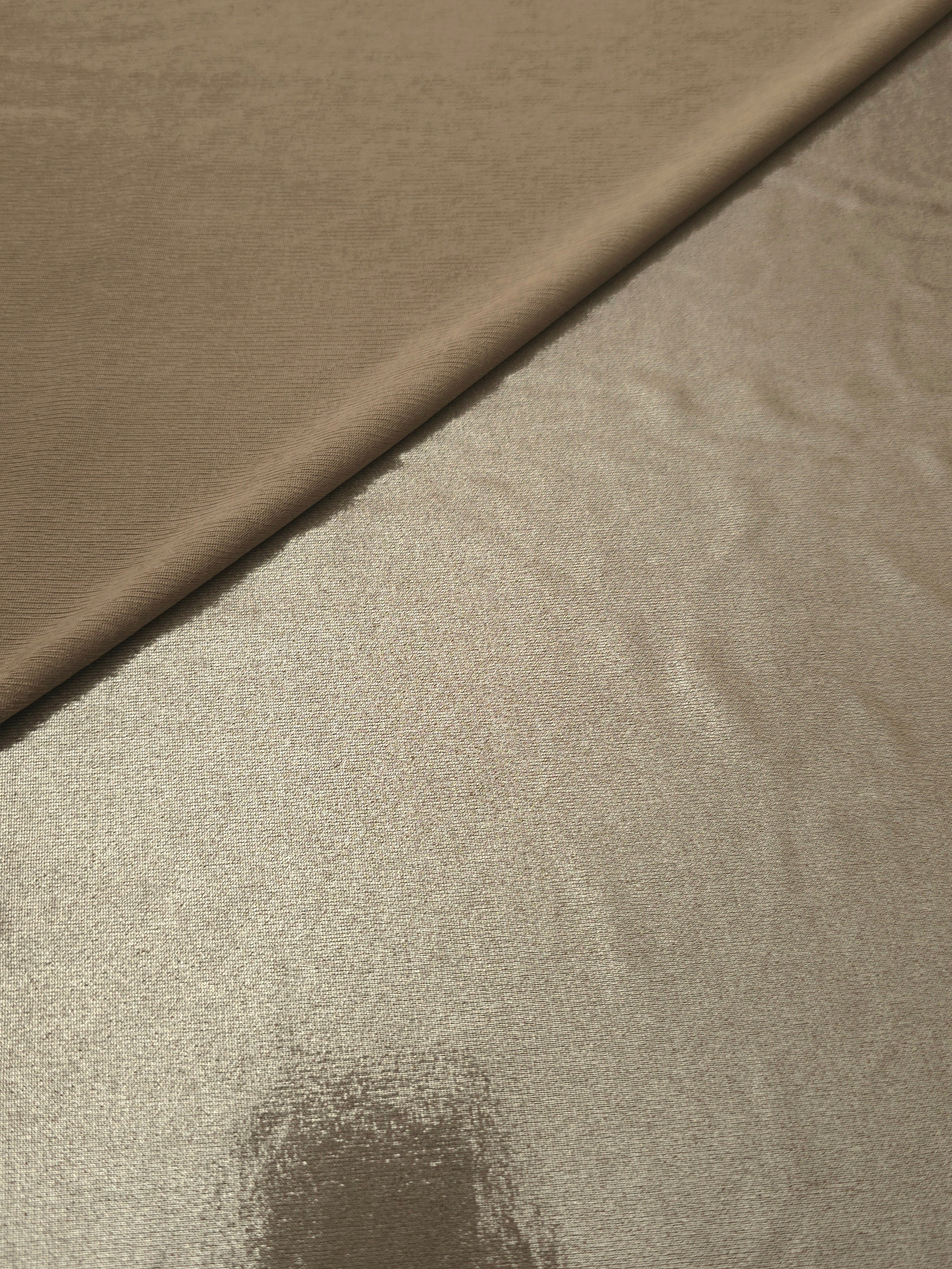 Warm Greige Beige shimmer spandex in a soft fold, showing metallic foil sheen and flexible drape for tops, skirts and costumes