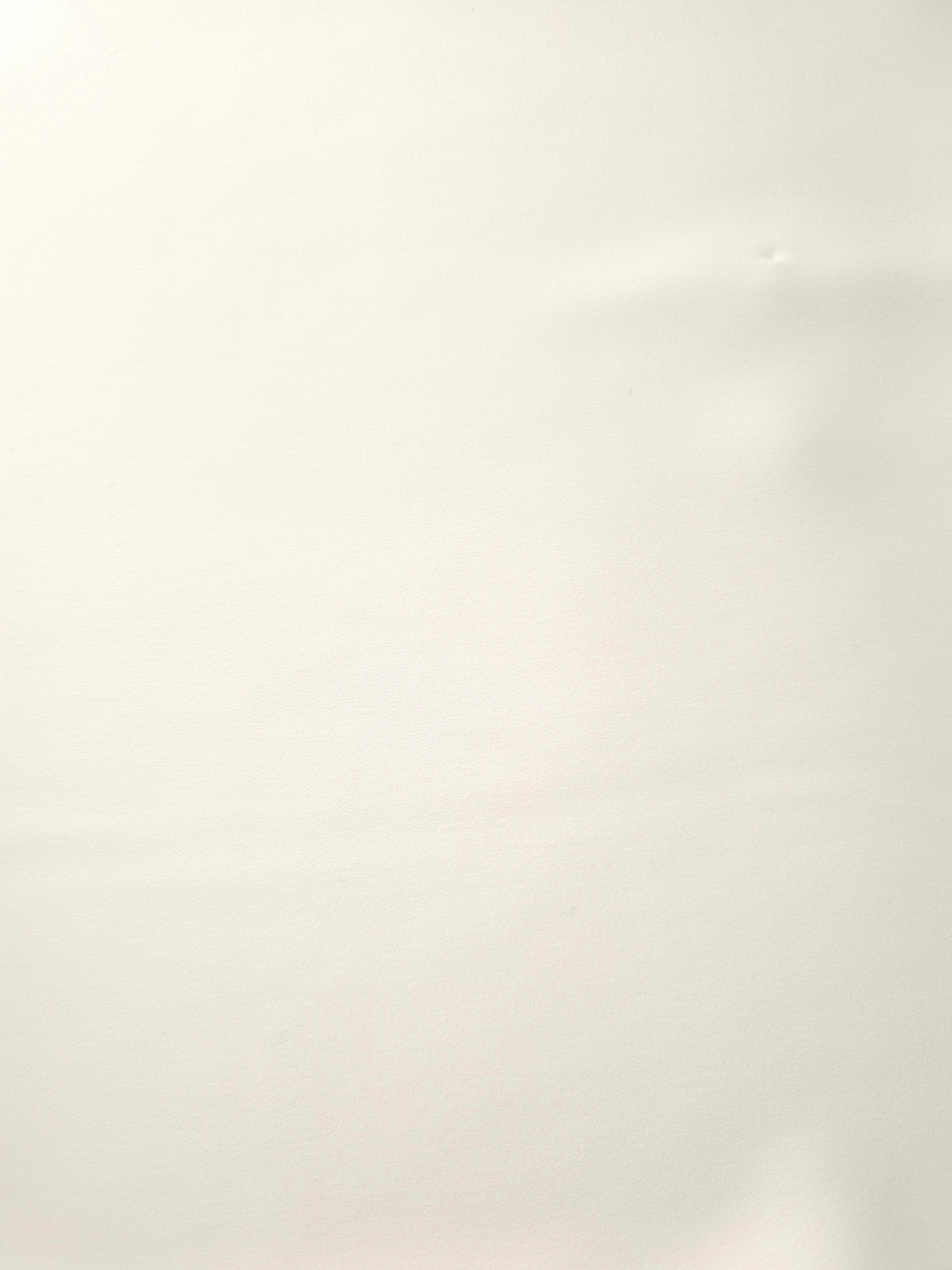 Warm Ivory Italian polyester crepe shown flat, smooth apparel fabric with a soft silky-feel finish