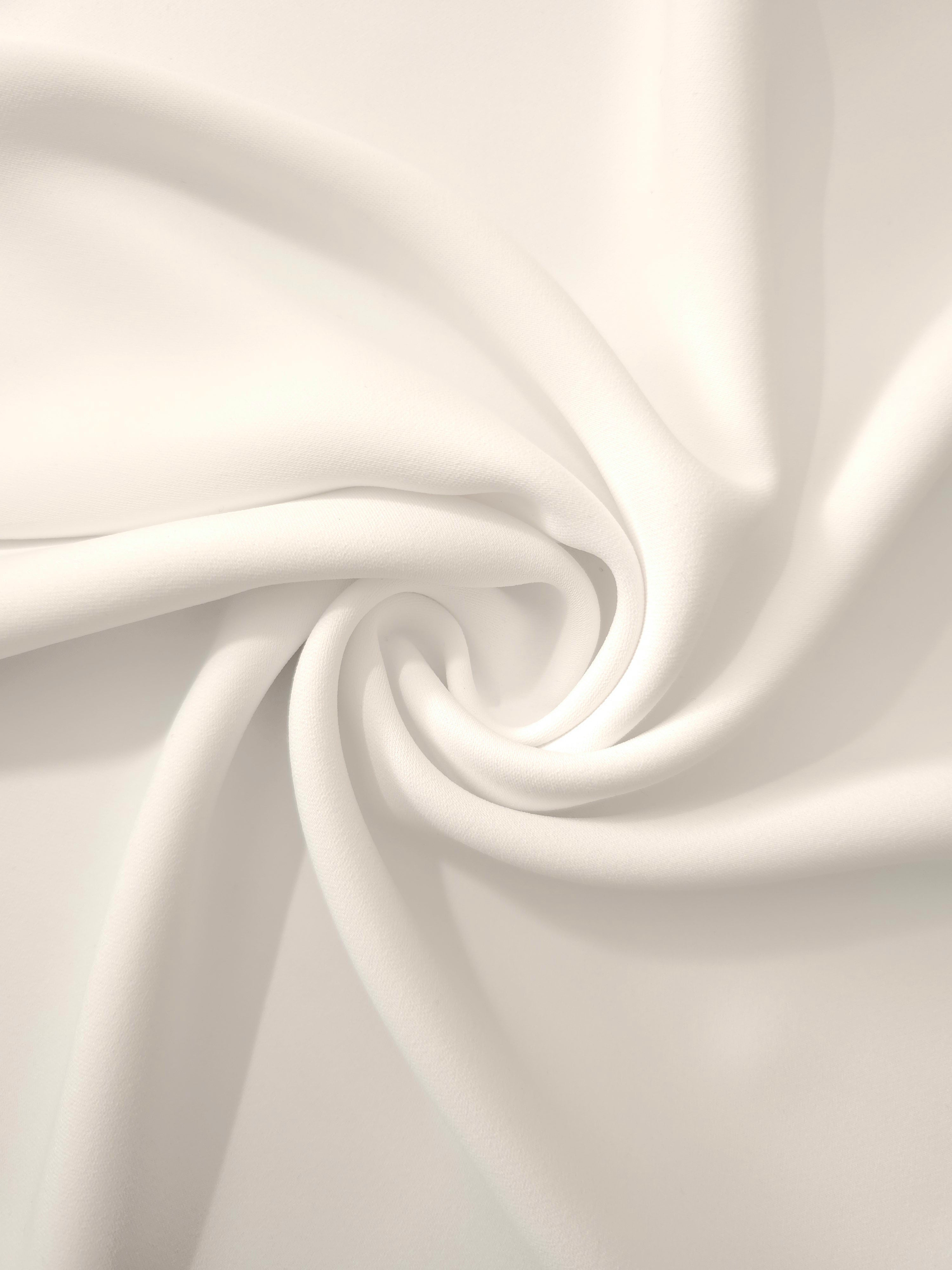 Warm Ivory silky-feel polyester crepe in a flowing swirl, showing drape for abayas and modest fashion