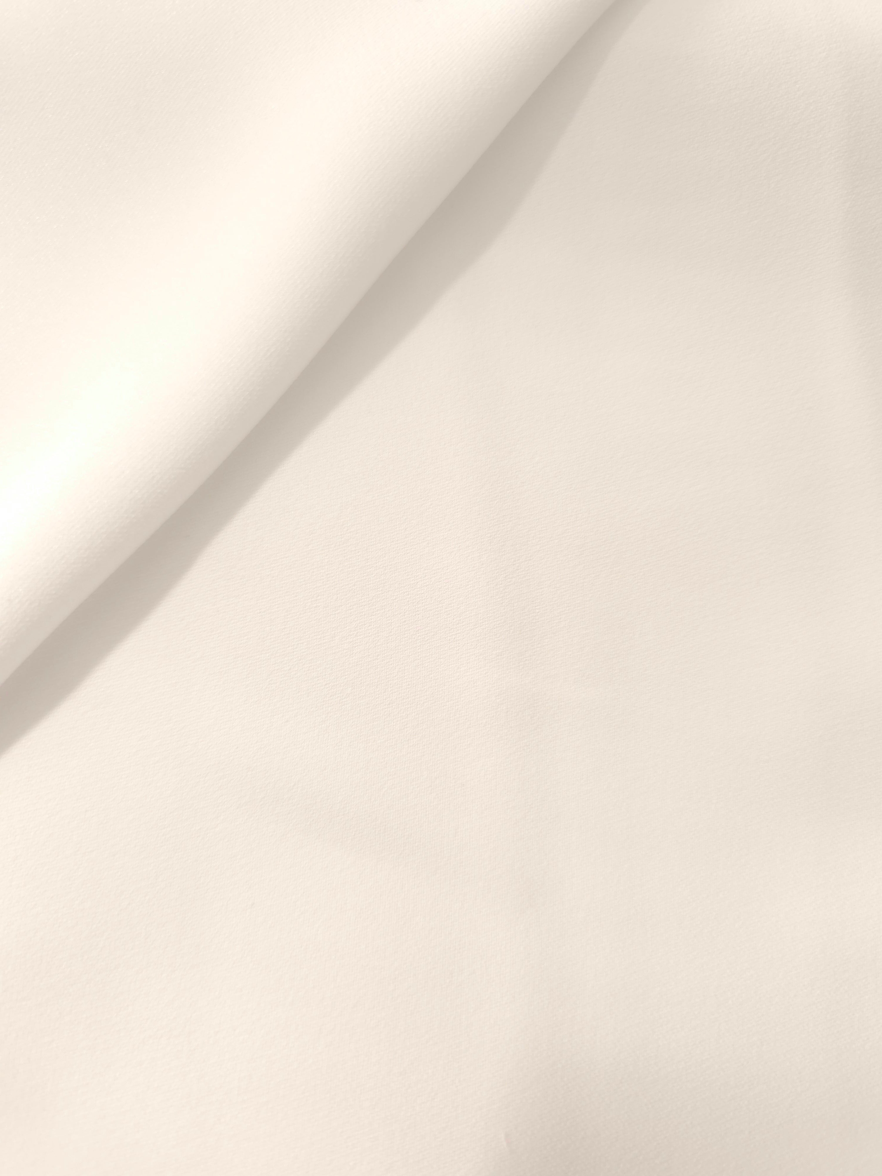 Warm Ivory Italian crepe in a soft fold, showing fluid drape for blouses, dresses and flowing skirts