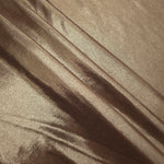 Layered Warm Mushroom Taupe metallic stretch fabric with reflective foil finish, showing flexible body for dancewear and occasion fashion