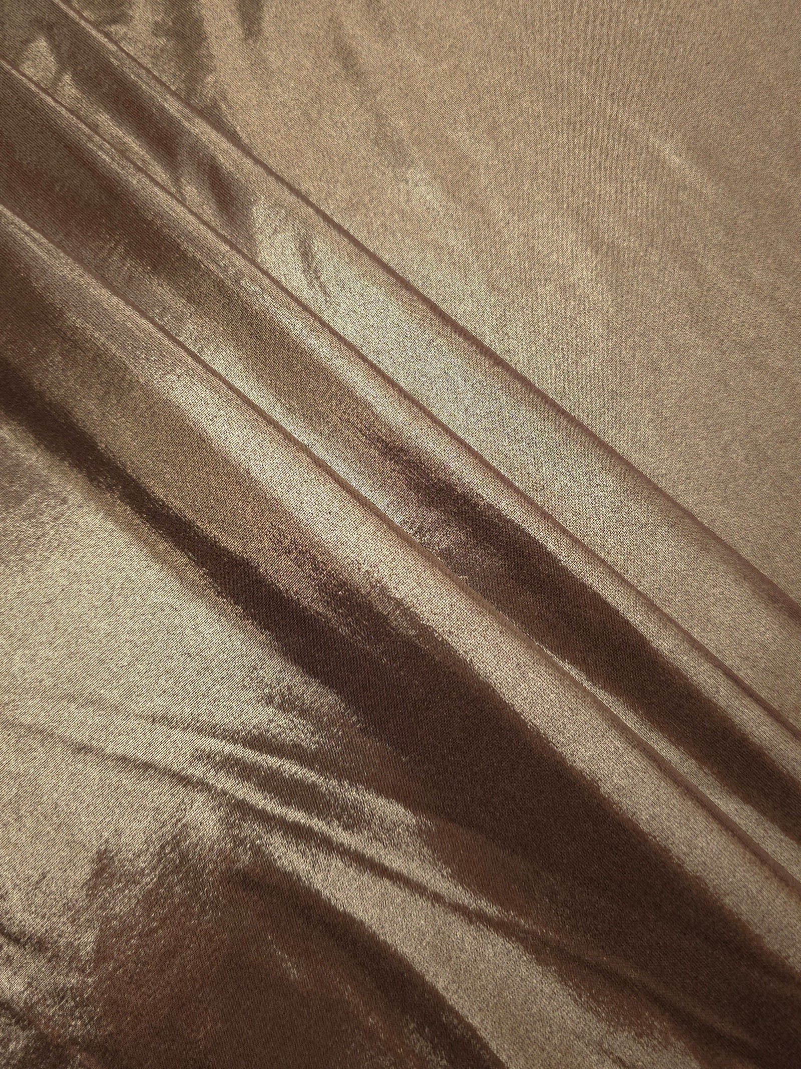Layered Warm Mushroom Taupe metallic stretch fabric with reflective foil finish, showing flexible body for dancewear and occasion fashion