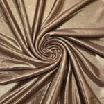 Warm Mushroom Taupe foiled spandex styled in a swirl, revealing metallic shine and flexible drape for dance costumes and occasion looks