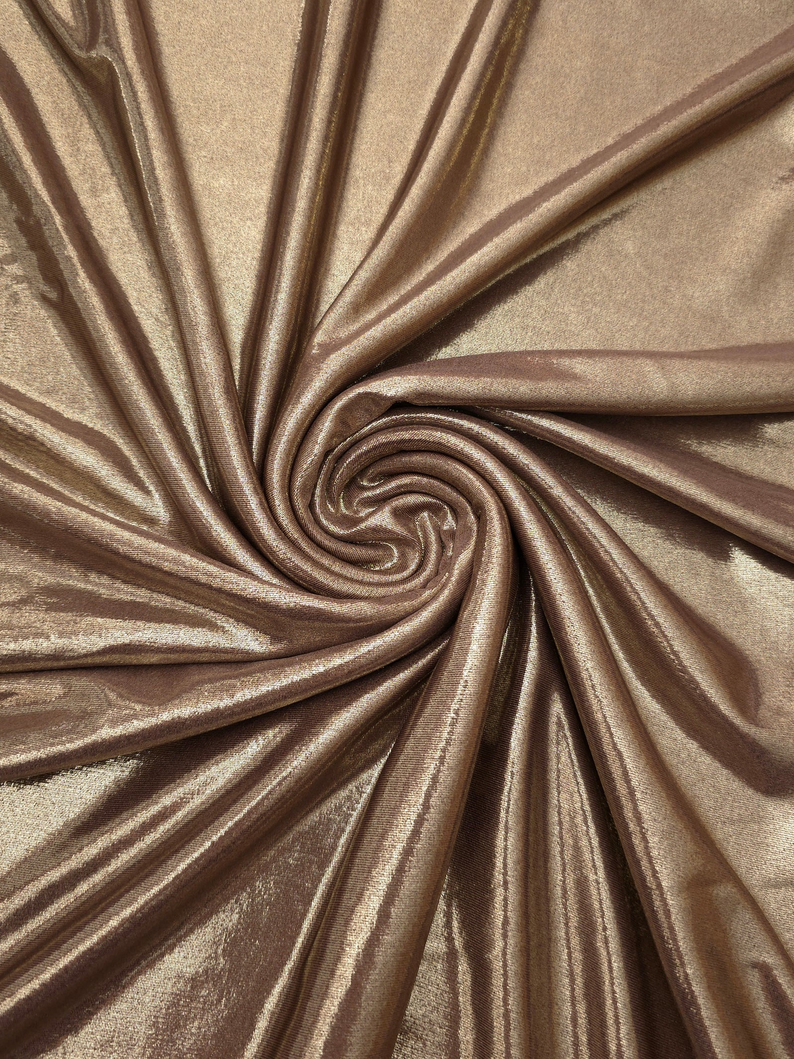 Warm Mushroom Taupe foiled spandex styled in a swirl, revealing metallic shine and flexible drape for dance costumes and occasion looks