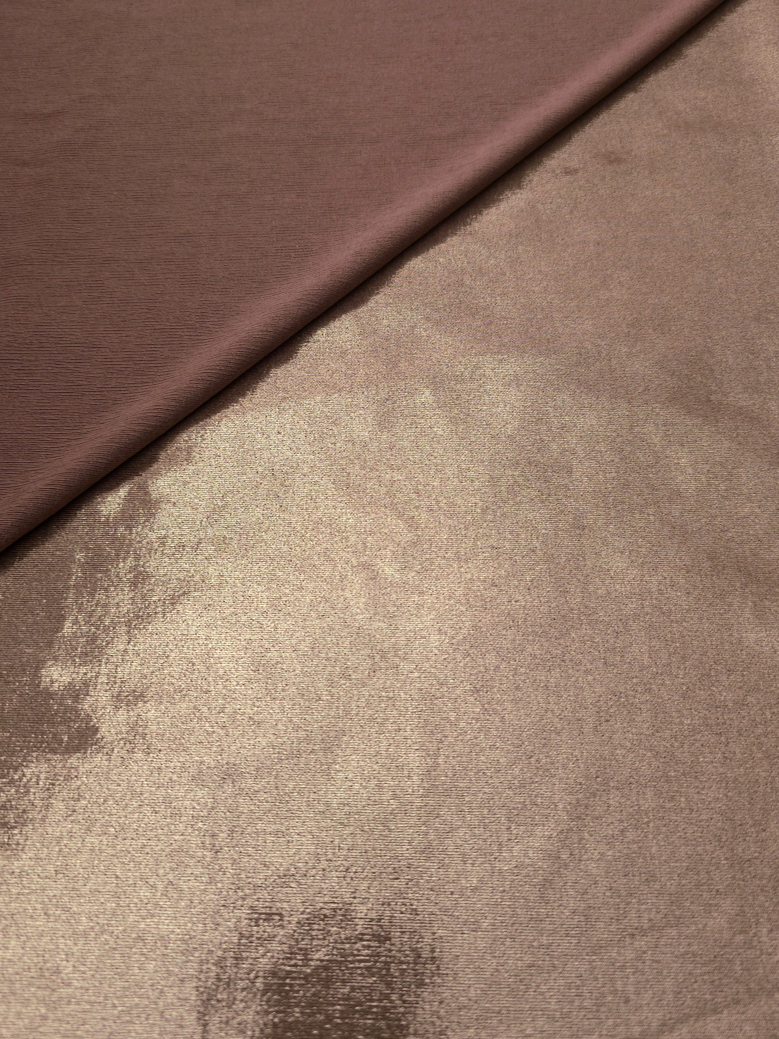 Warm Mushroom Taupe metallic stretch fabric in a soft fold, revealing reflective drape for dancewear, dresses and statement apparel