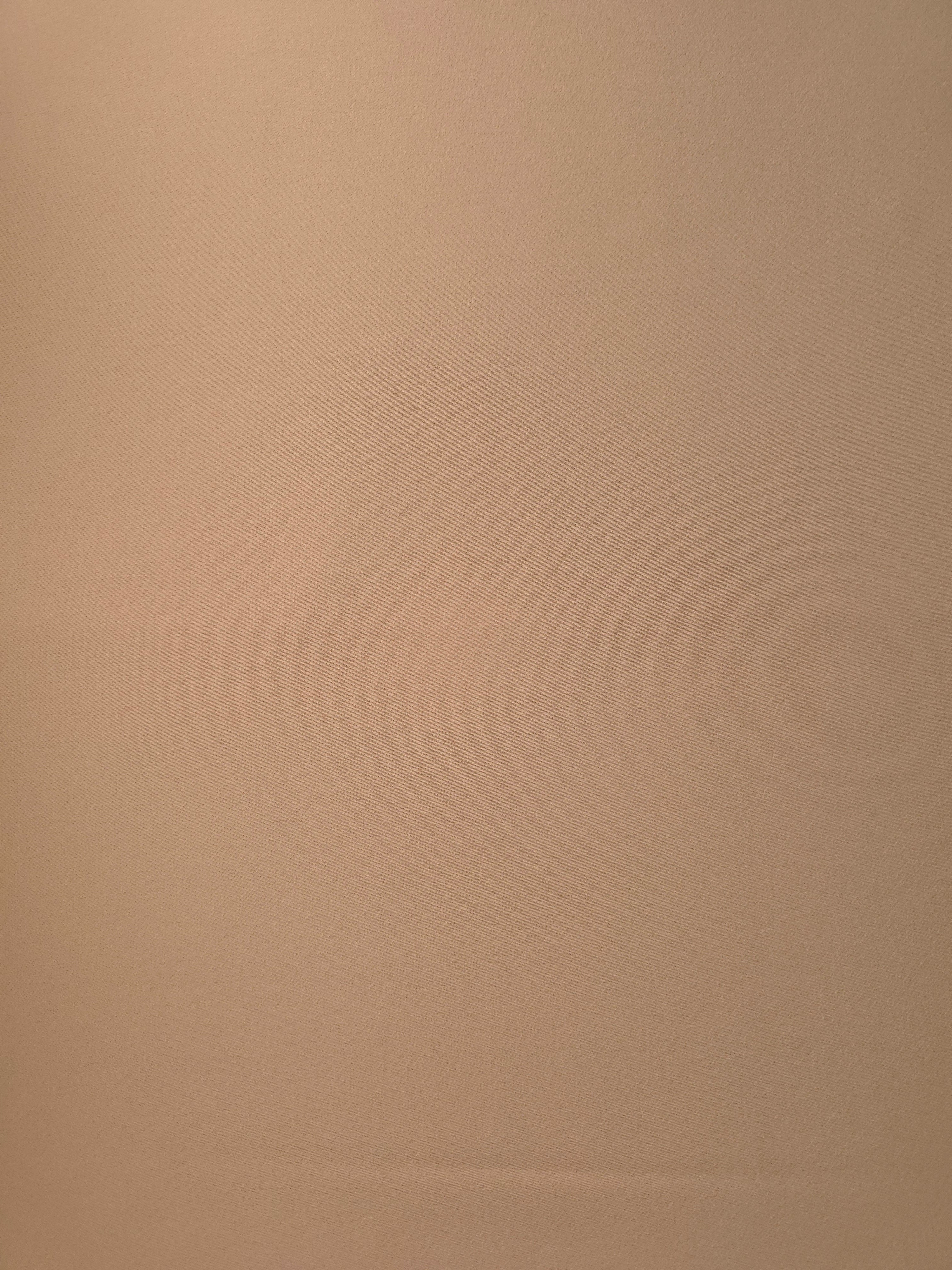 Flat surface of Warm Sand Beige Italian crepe, smooth polyester apparel fabric with an elegant silky-feel character