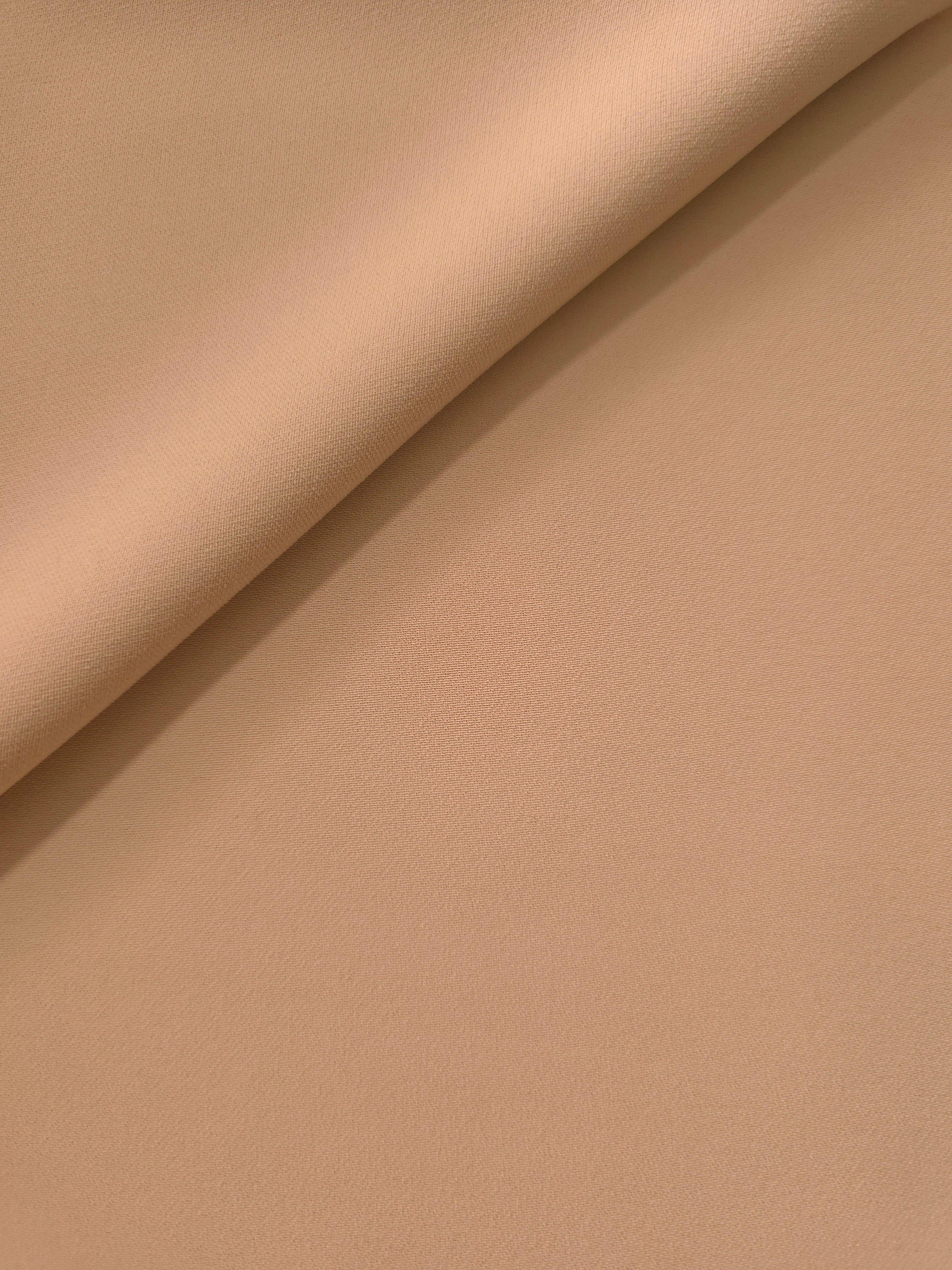 Soft-fold view of Warm Sand Beige Italian polyester crepe showing fluid drape for blouses, skirts and dresses