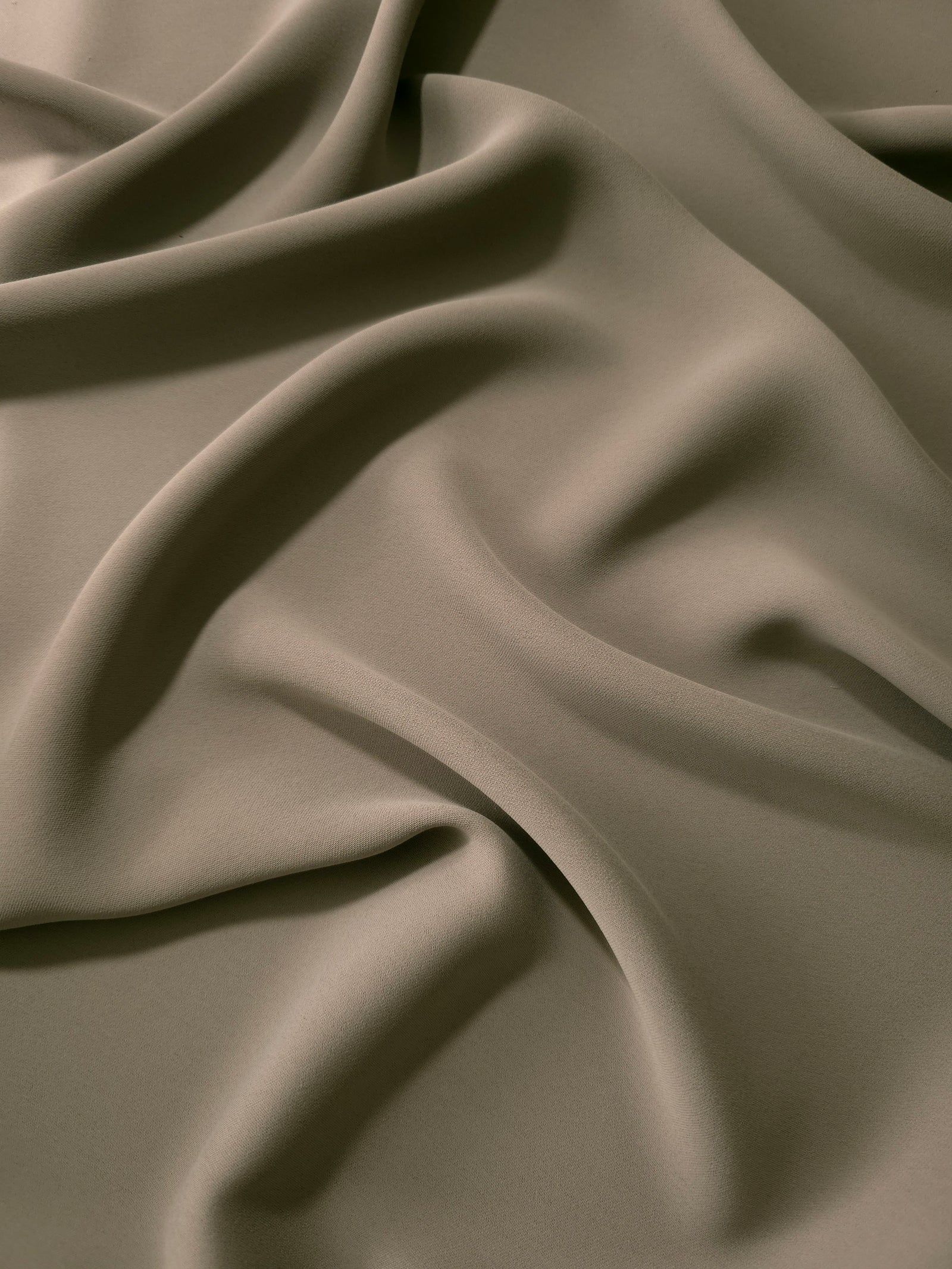 Fluid folds of Warm Stone Taupe opaque Korean crepe, a dress fabric suited to eveningwear and flowing skirts